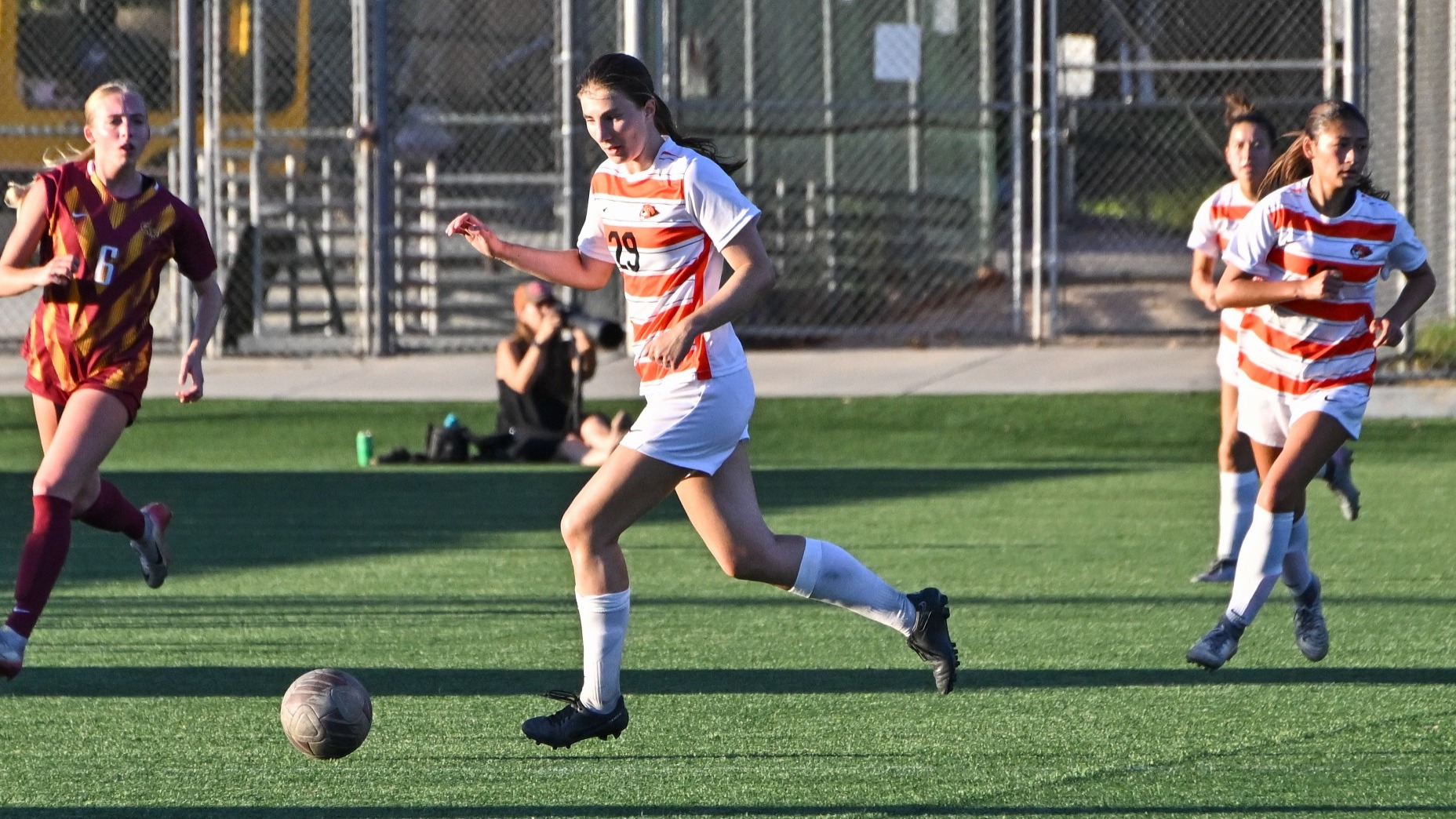Alexa Baxter dribbling the ball past a CMS defender
