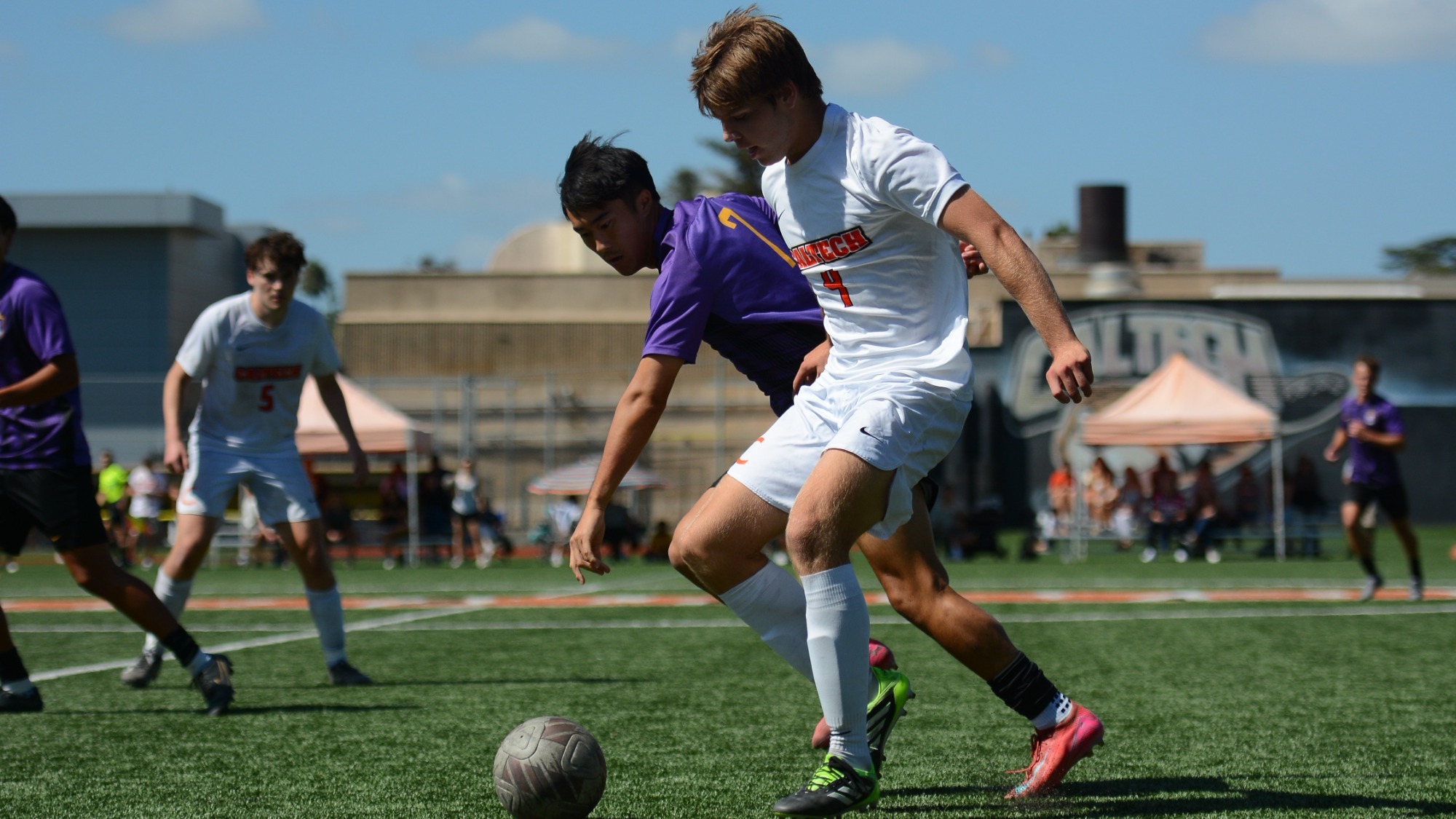 Aritz Schube protects the ball from a Cal Lutheran player around midfield