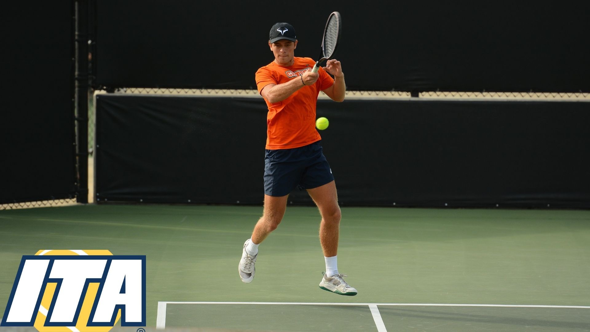 Constantin Cedillo-Vayson de Pradenne elevates off the ground as he hits a shot near the sideline. An ITA logo is placed in the bottom left corner of the image 