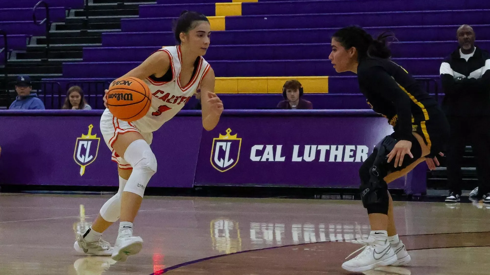 Zeynep Goektepe dribbling the ball while a Texas Lutheran player defends