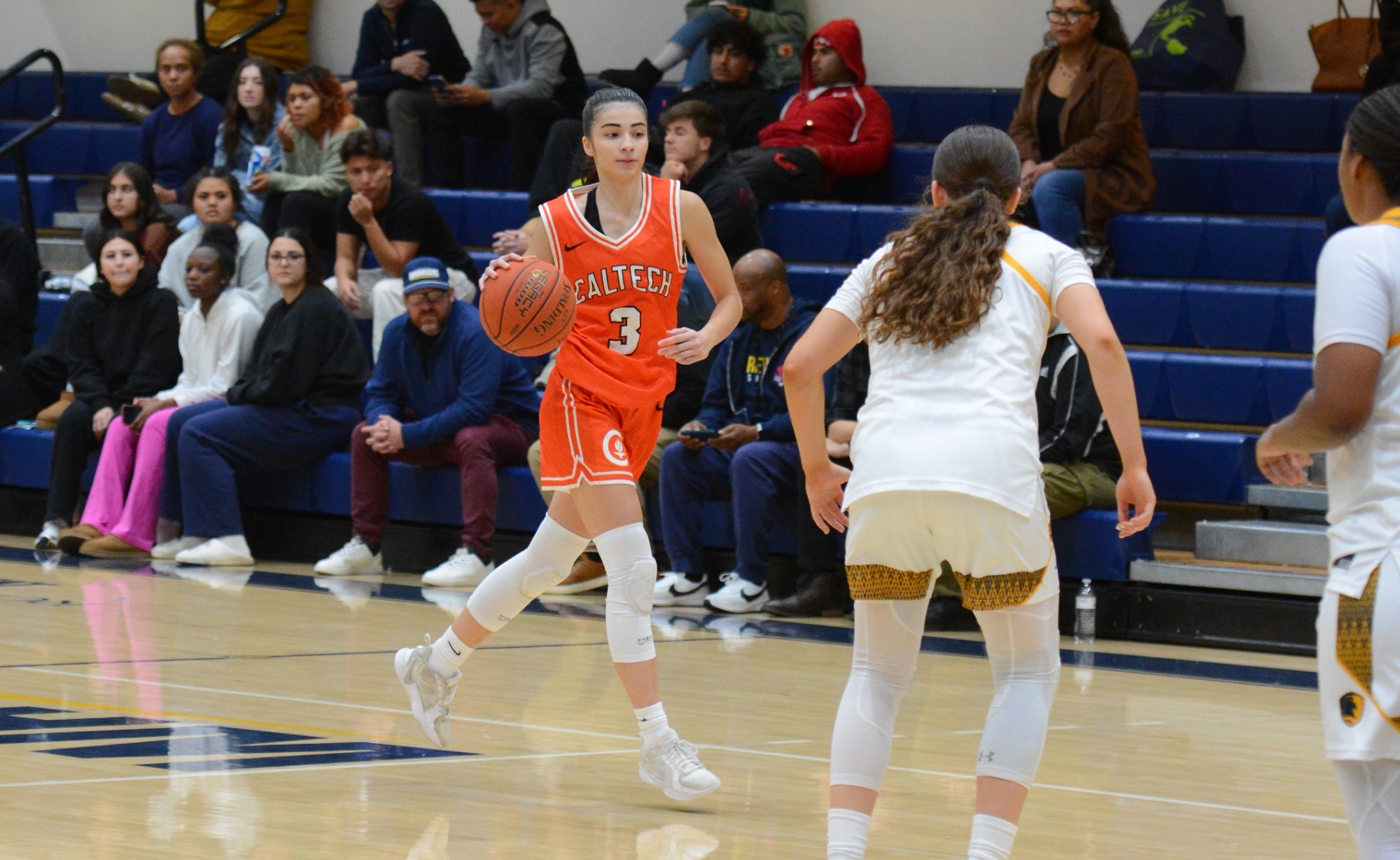 Zeynep Goktepe dribbles toward a pair of Life Pacific defenders
