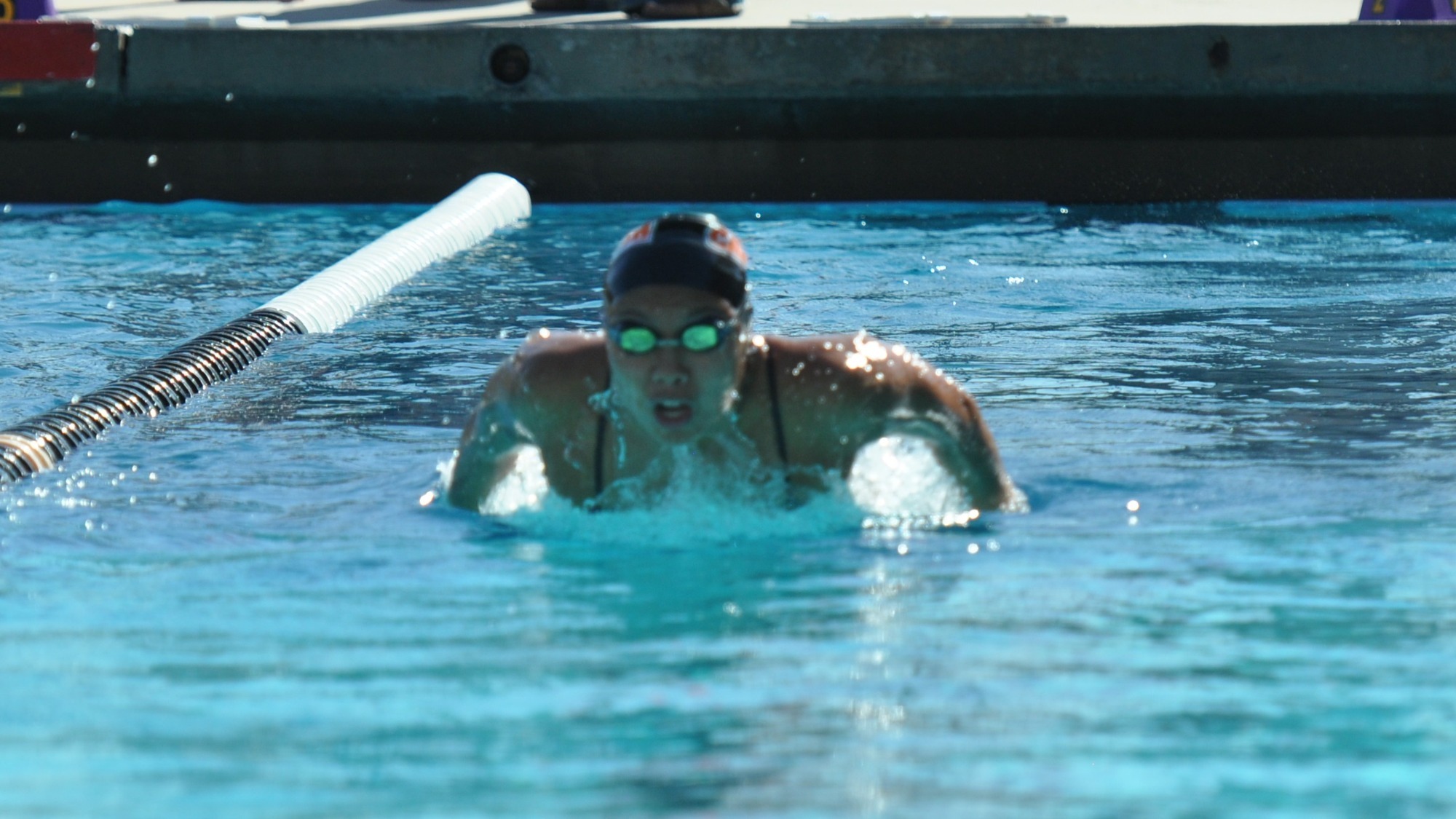 Kaylah Rhee lifts her head out of the water in the middle of a butterfly stroke. 