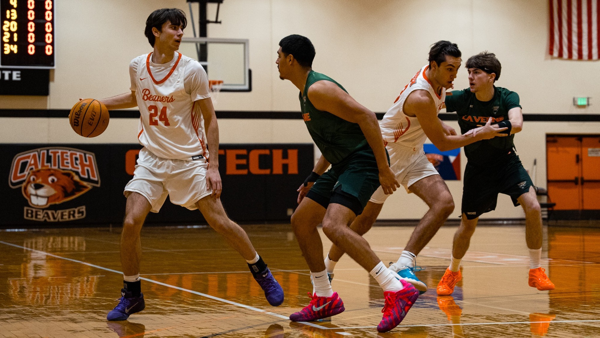 Dorian Glogovac dribbling evaluates his options as he dribbles against a La Verne defender at the three-point line
