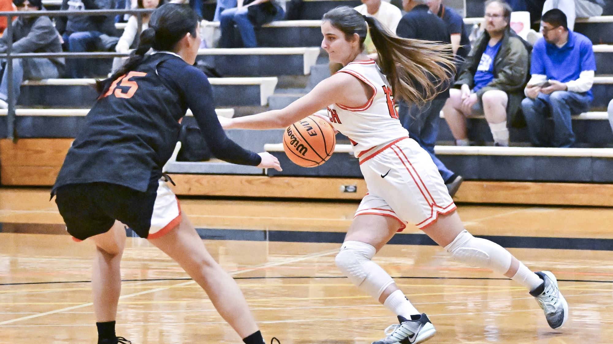 Anamaria Robertson dribbling with a defender to her left
