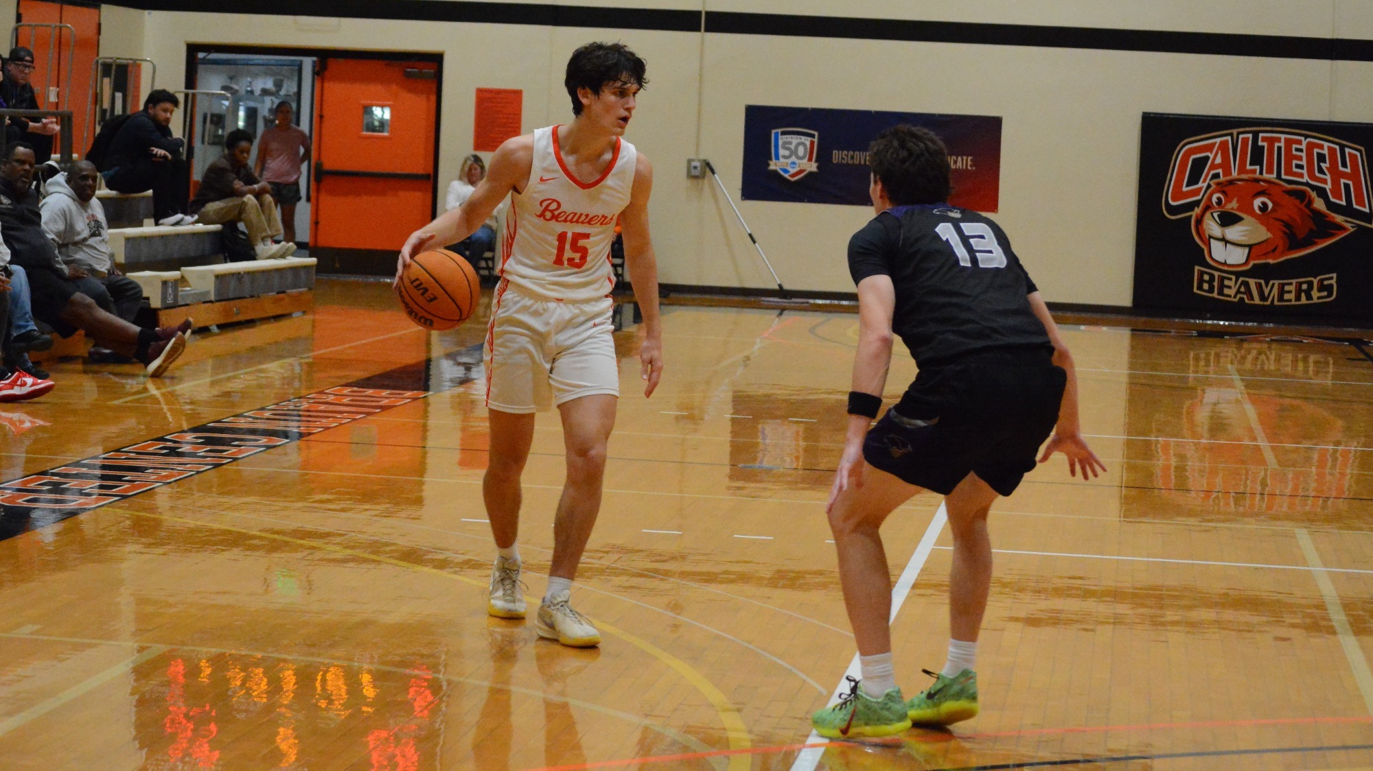 Ryan Rodrigue dribbles against his defender beyond the arc against Whittier