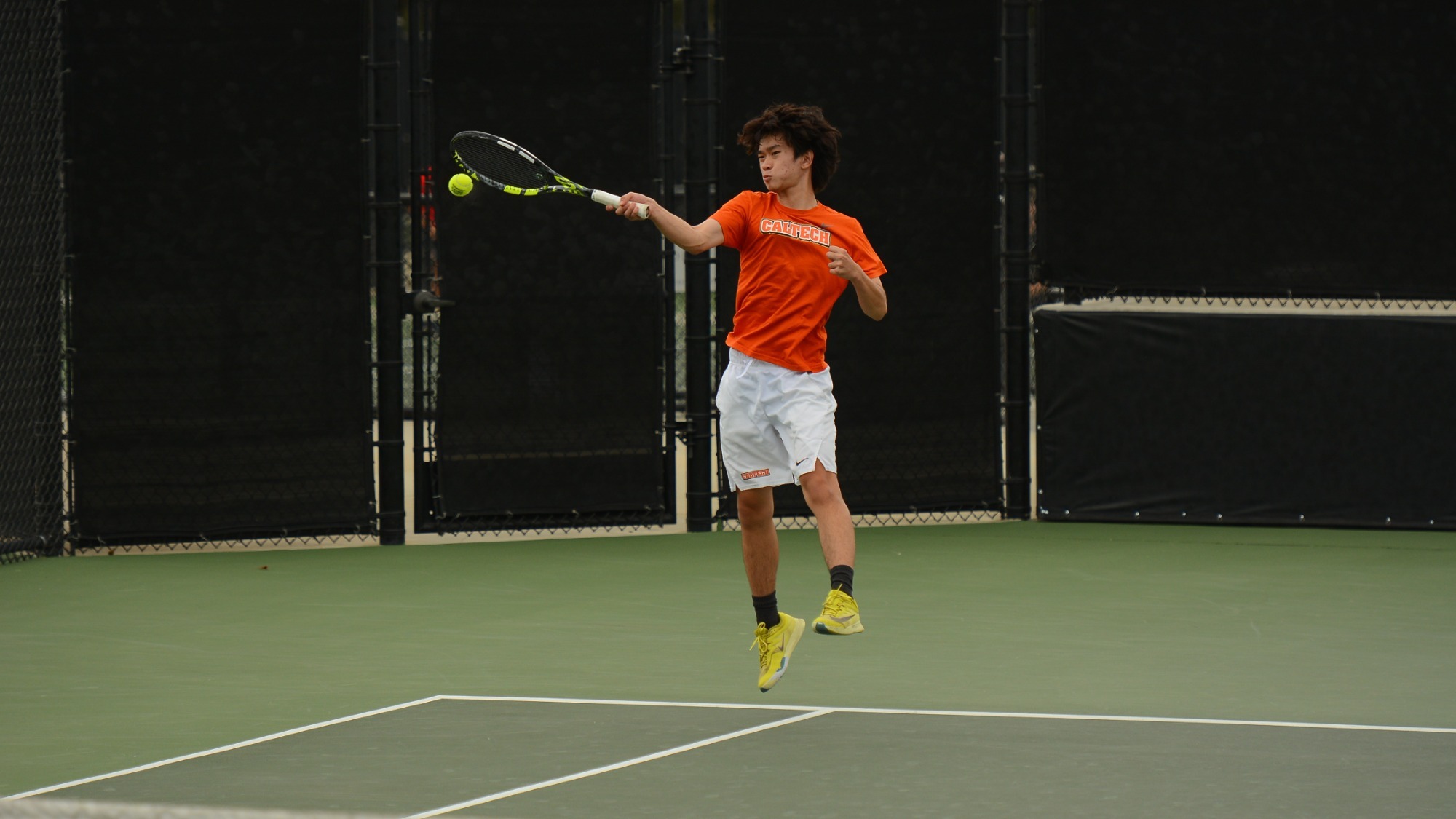 Gao elevates from the ground near the right sideline while attacking a ball with a right-armed swing. 