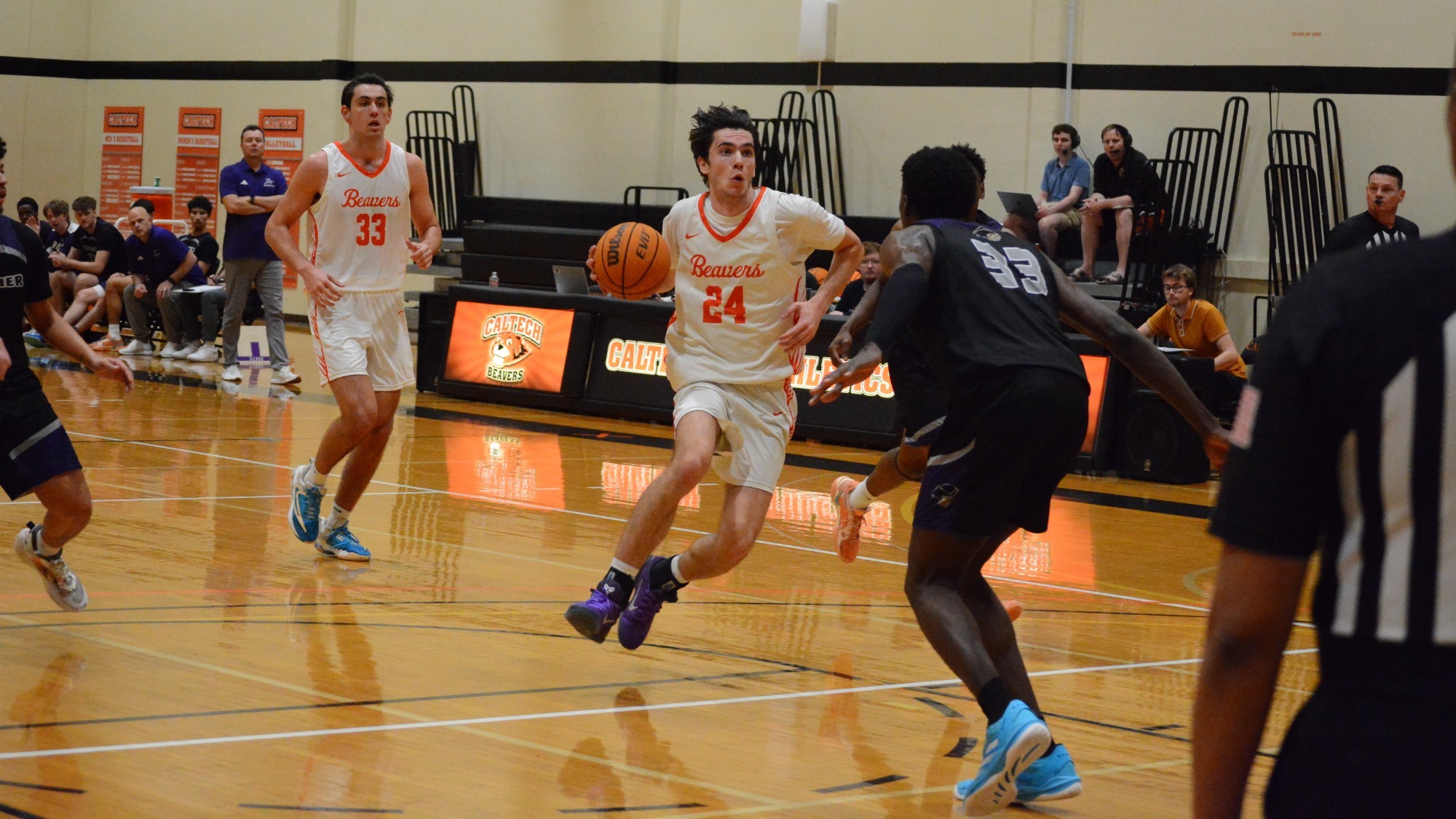 Glogovac driving vs Whitter carrying the ball in his right hand while elevating off the floor in the face of a defender. 