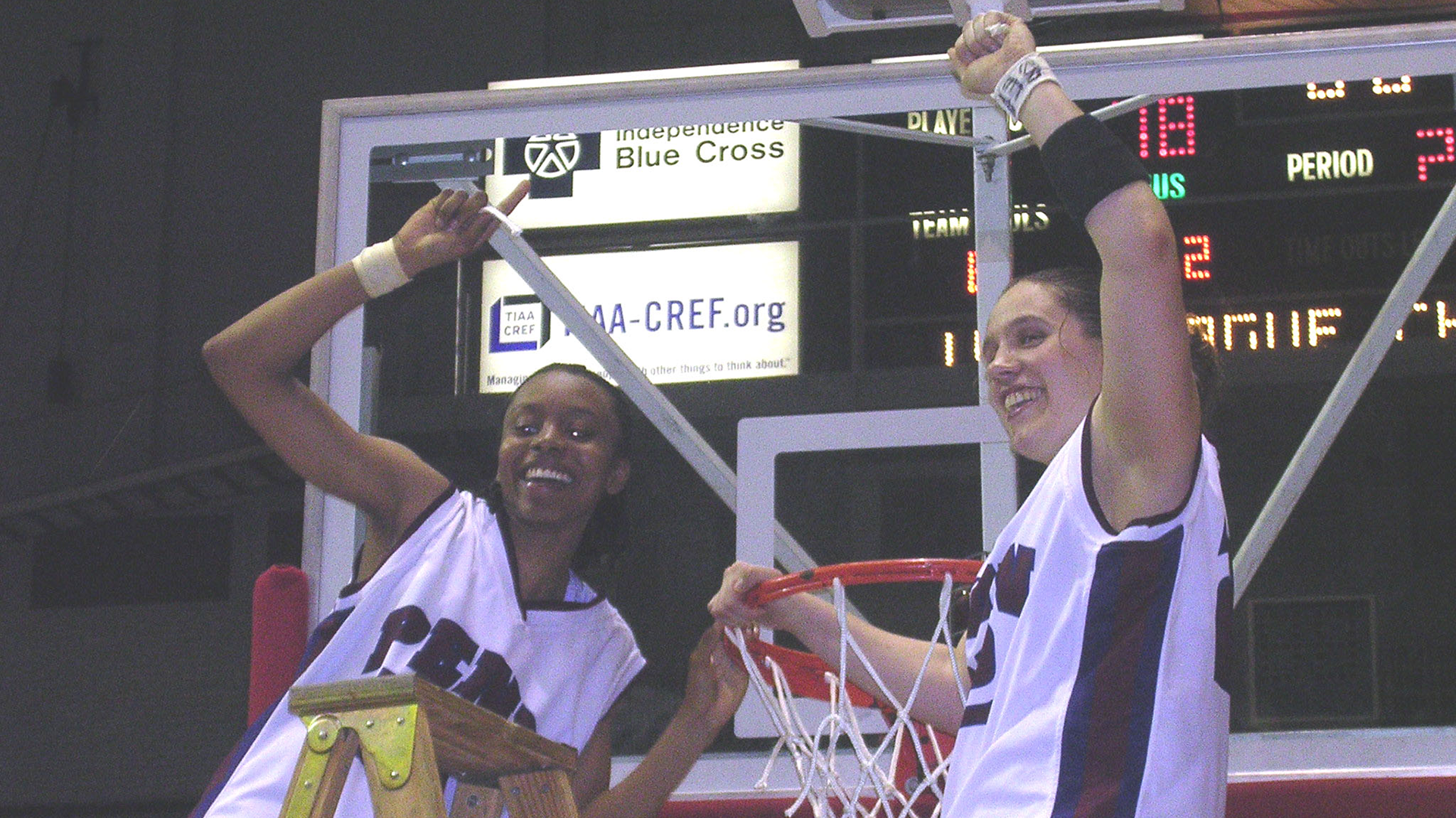 Jewel Clark (left) cuts down the net after one of the two Ivy League championships she experienced as a standout guard for the Quakers. 