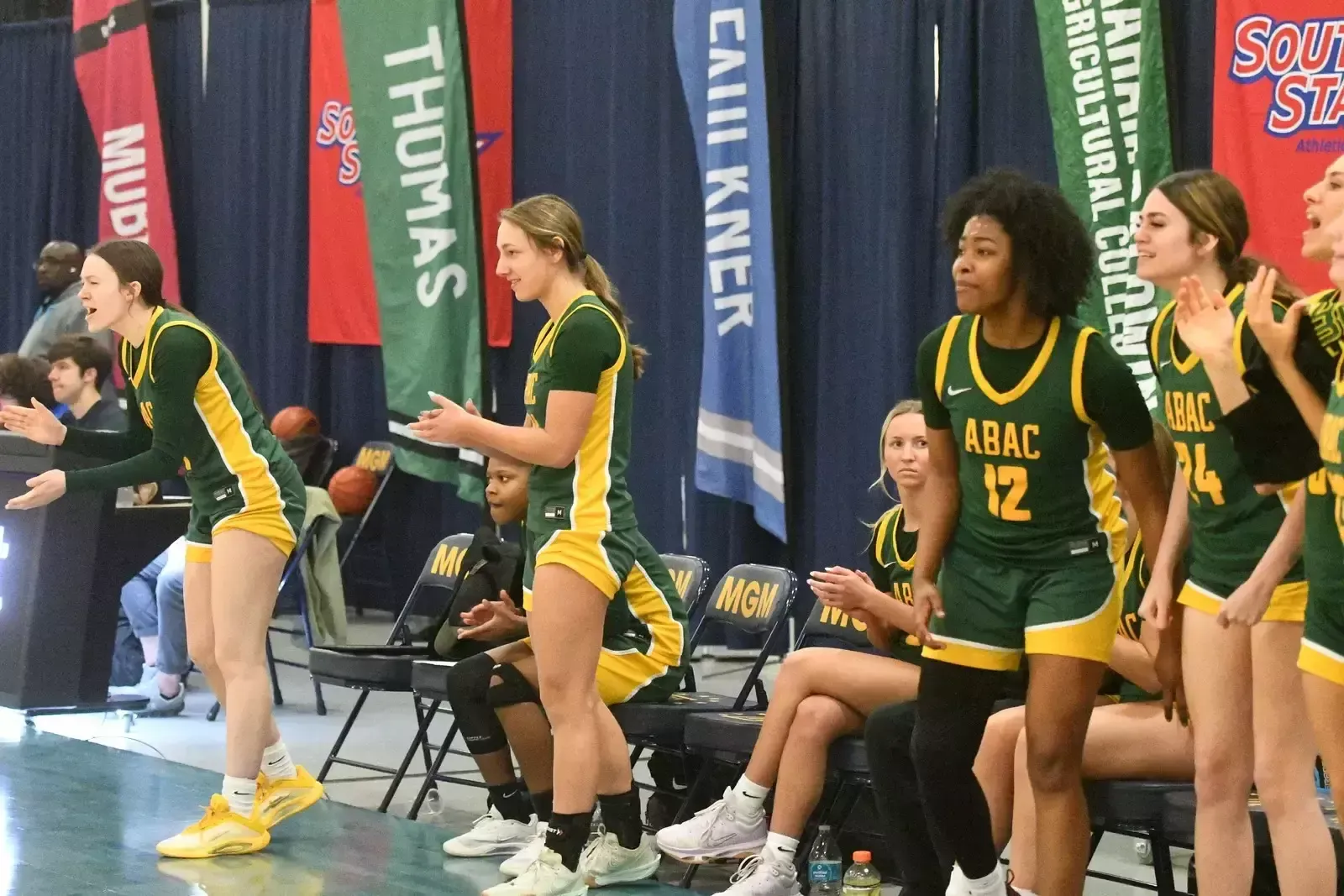 ABAC's bench cheers during their playoff game against Faulkner