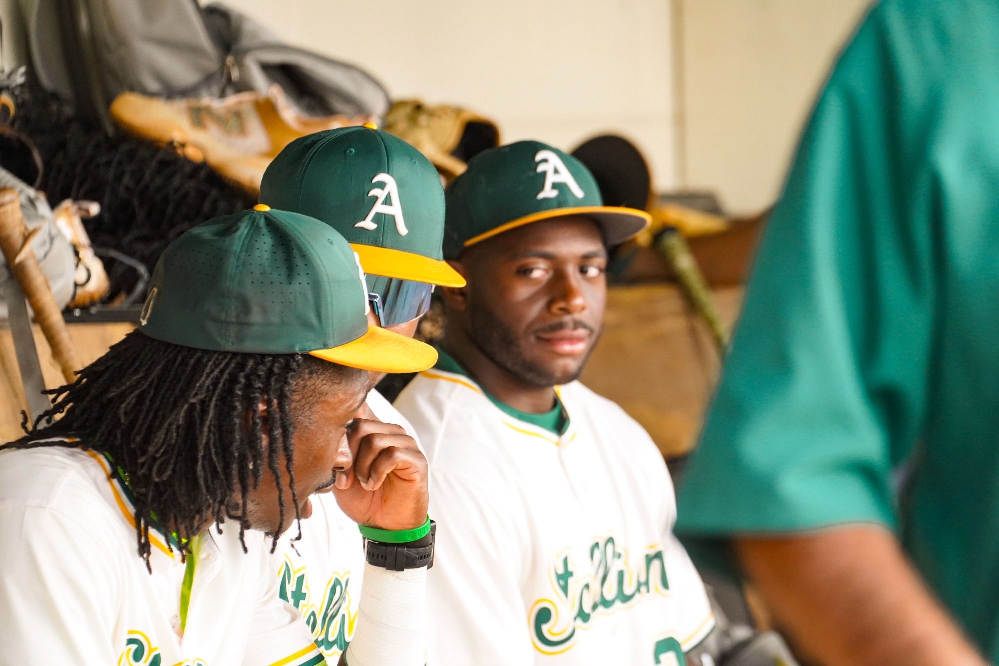 ABAC baseball players talk in the dugout