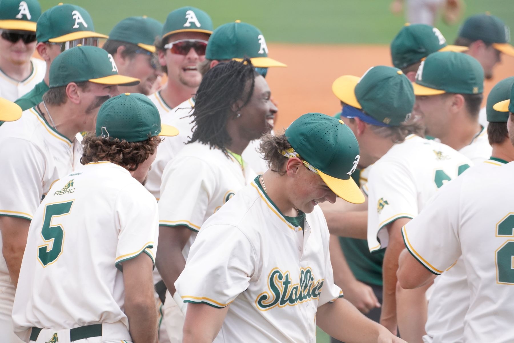 ABAC Stallions baseball celebrates scoring a run versus Loyola