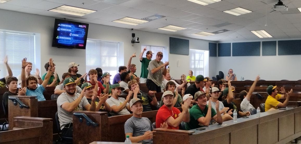 ABAC baseball players cheer after their NAIA baseball destination is announced May 6