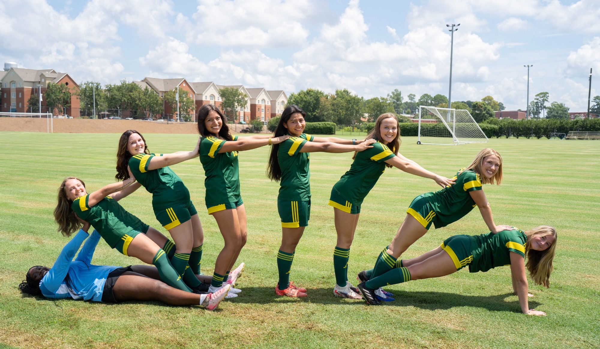 2026 women's soccer team forms an arch during a photoshoot