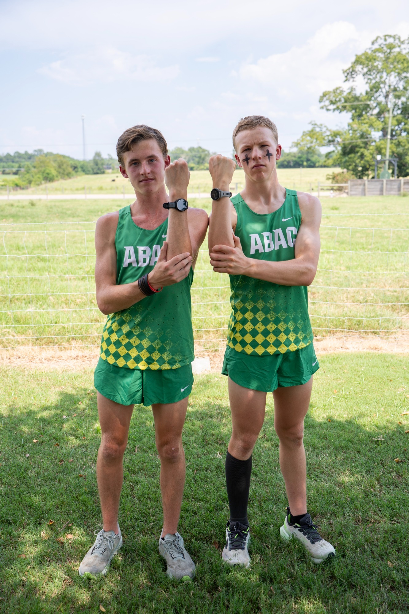 Cross country runners show their watches