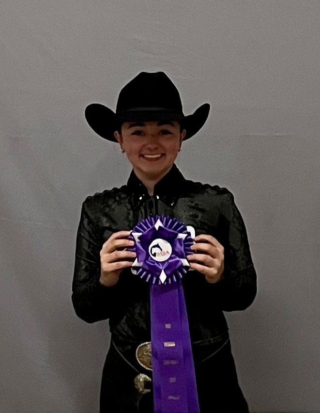 Madelina Casanova displays her seventh-place ribbon. Casanova and her teammates wrapped up their season at the IHSA Semifinals.