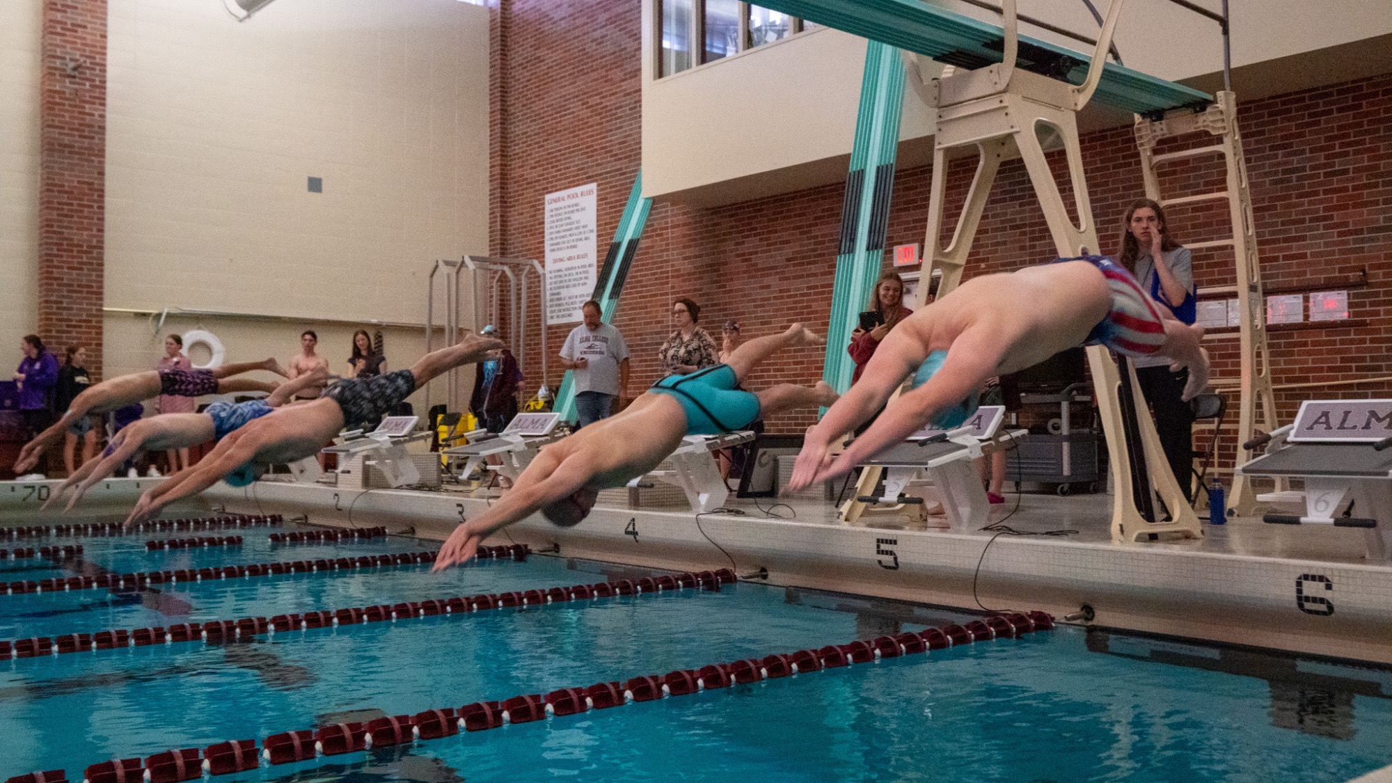 Swimmers dive in at a meet