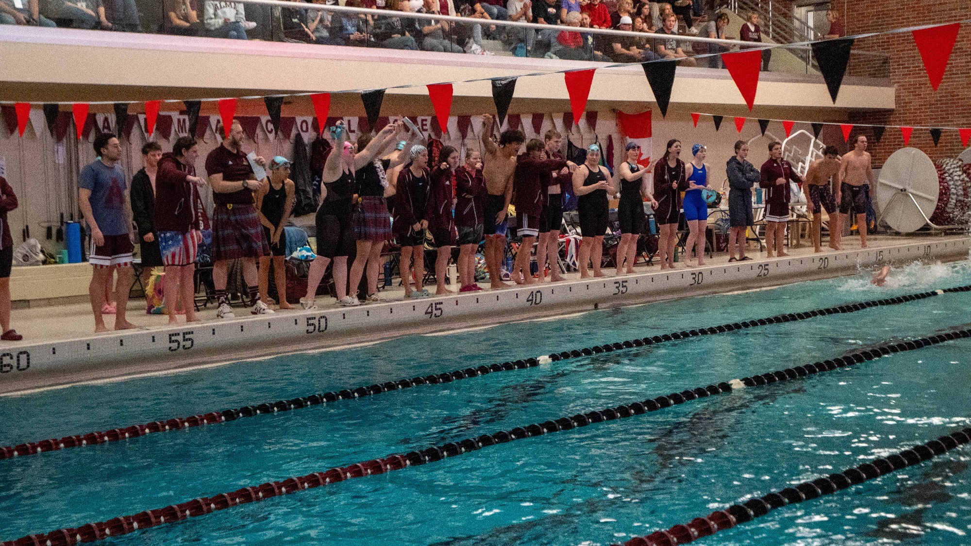 Swim cheers on the side during a race