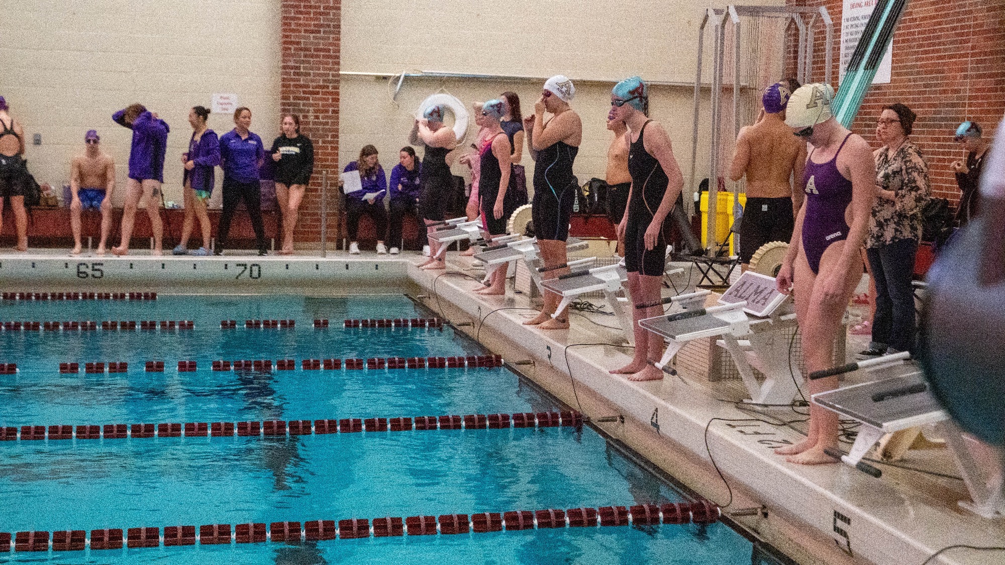 Swimming and Diving prepare for a backstroke event