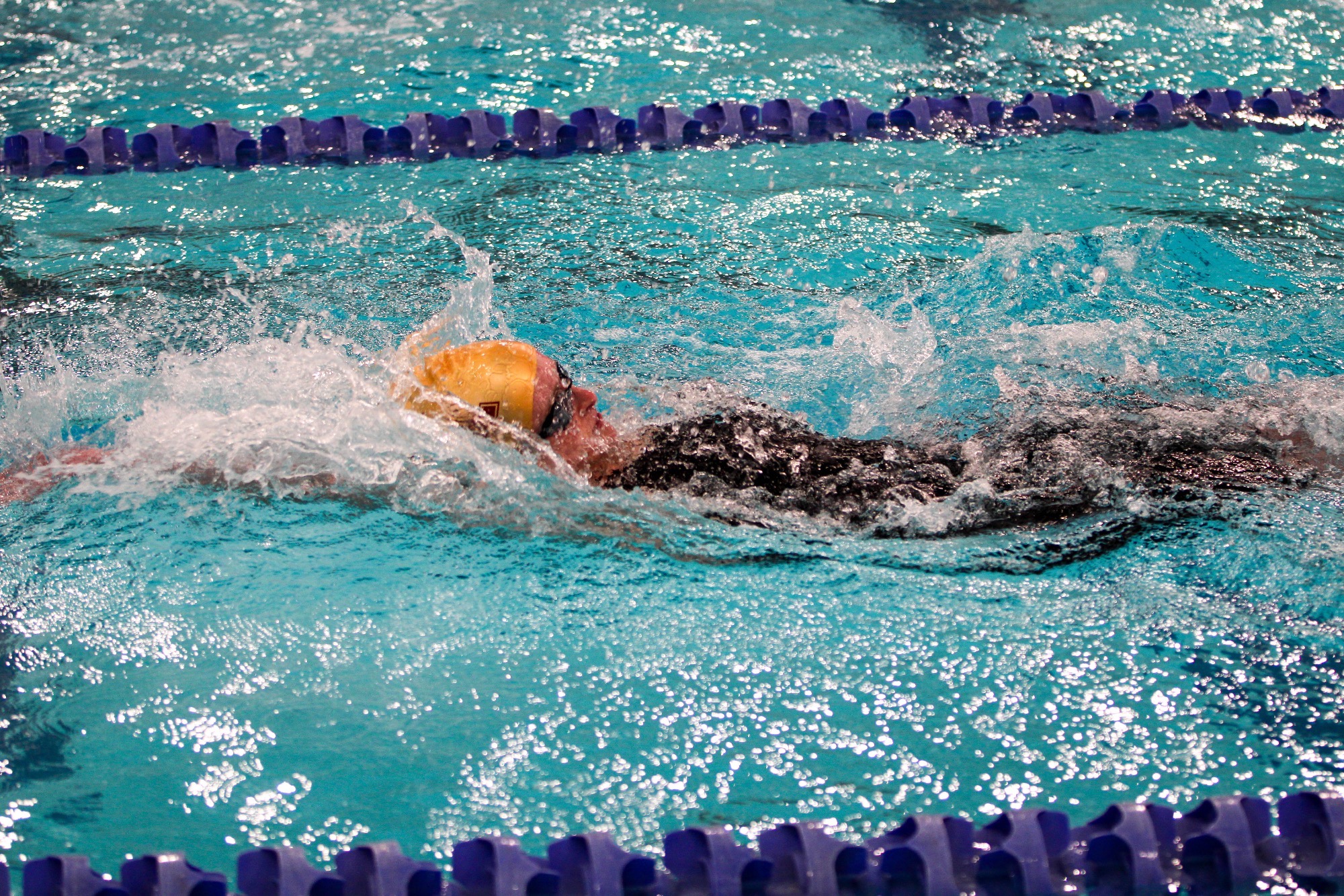 S Floros swims the backstroke
