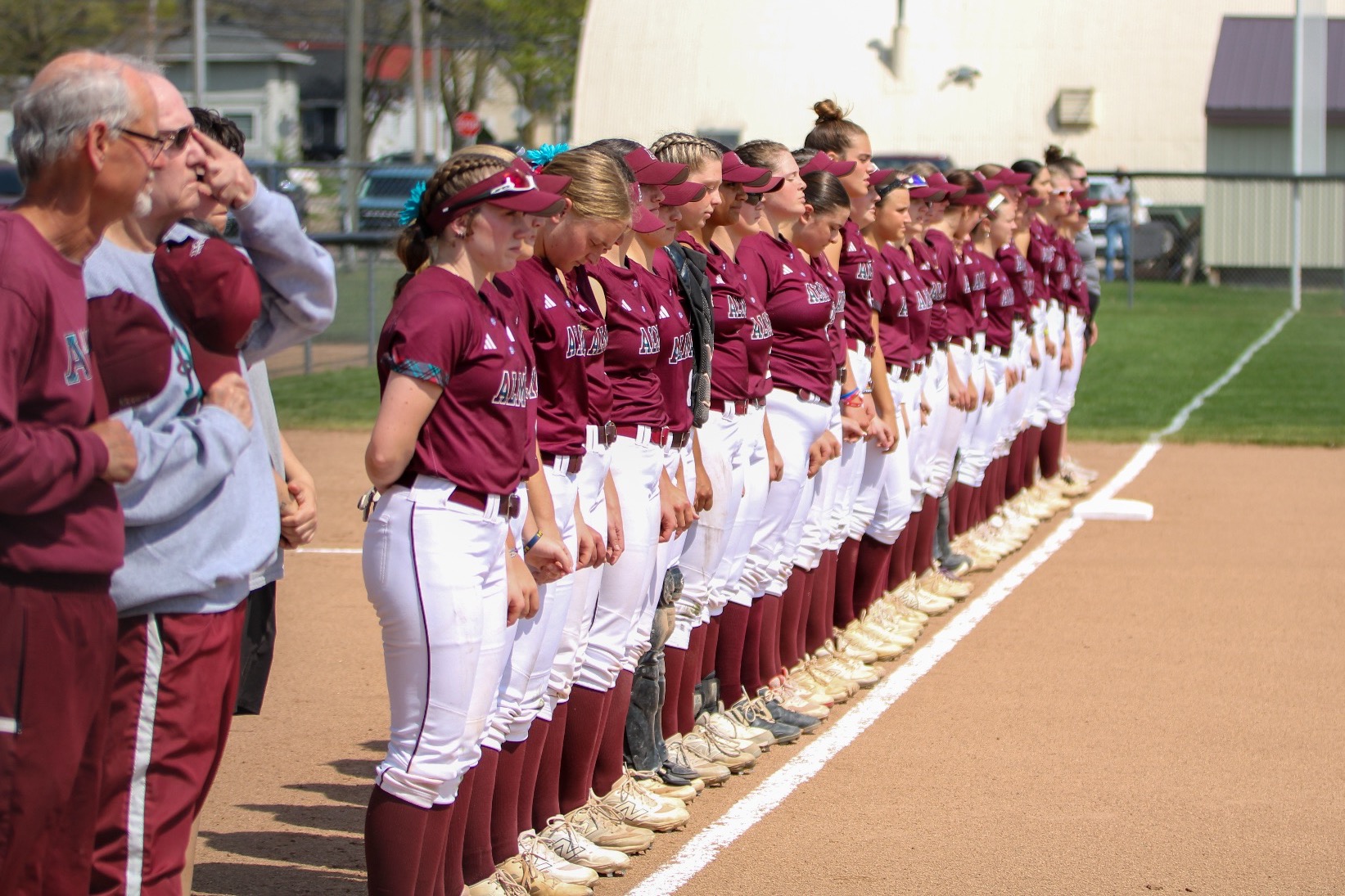 Softball team lines up for the national anthem