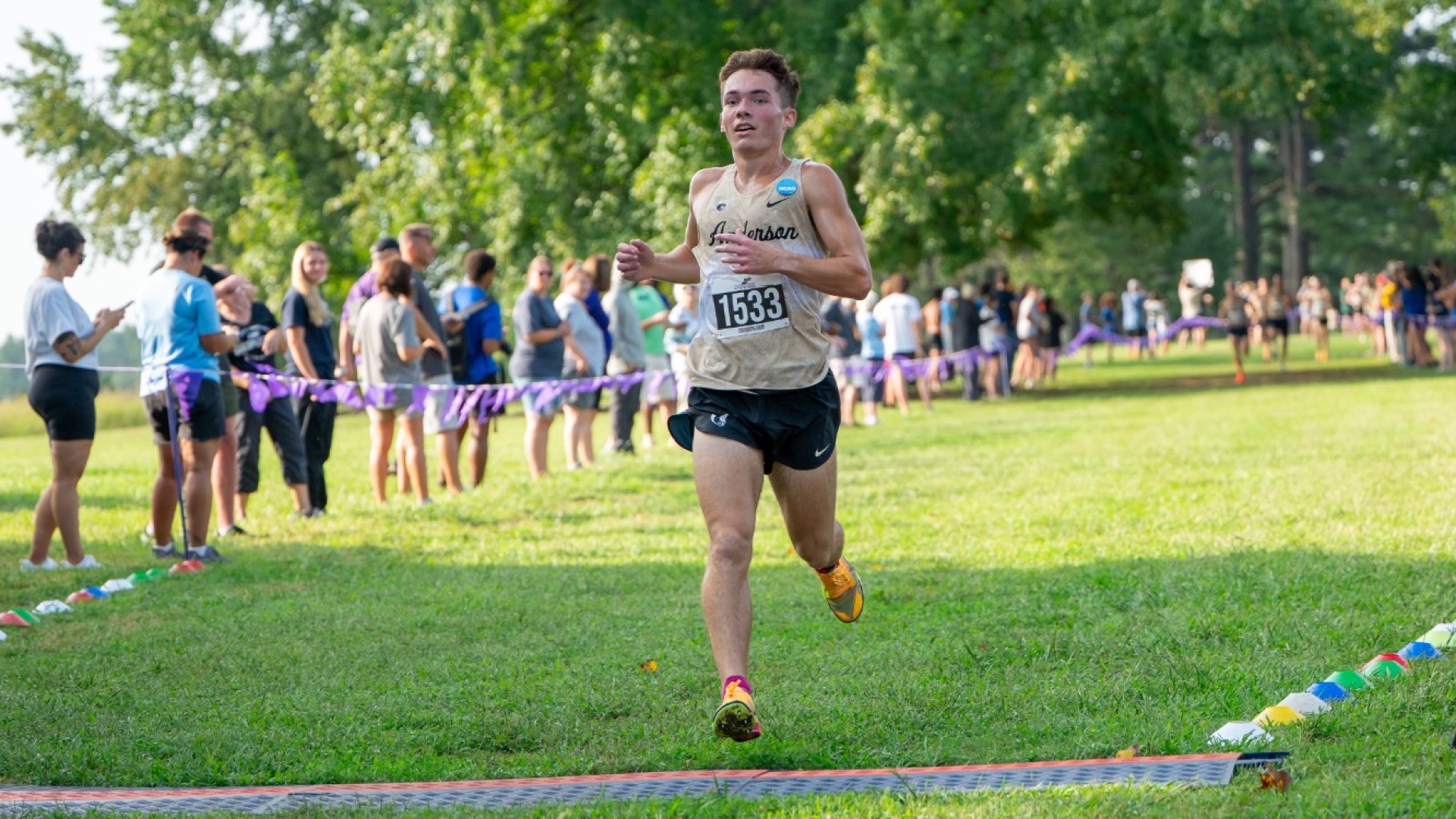 Gibbons crosses the finish line first to win the men's 8k at the Converse Kick-Off season opener
