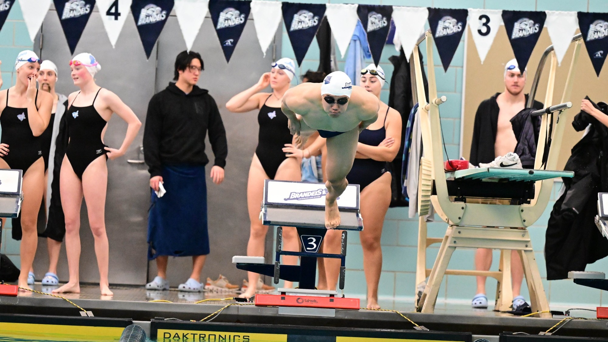 Eric Xiao dives into the pool to start a race