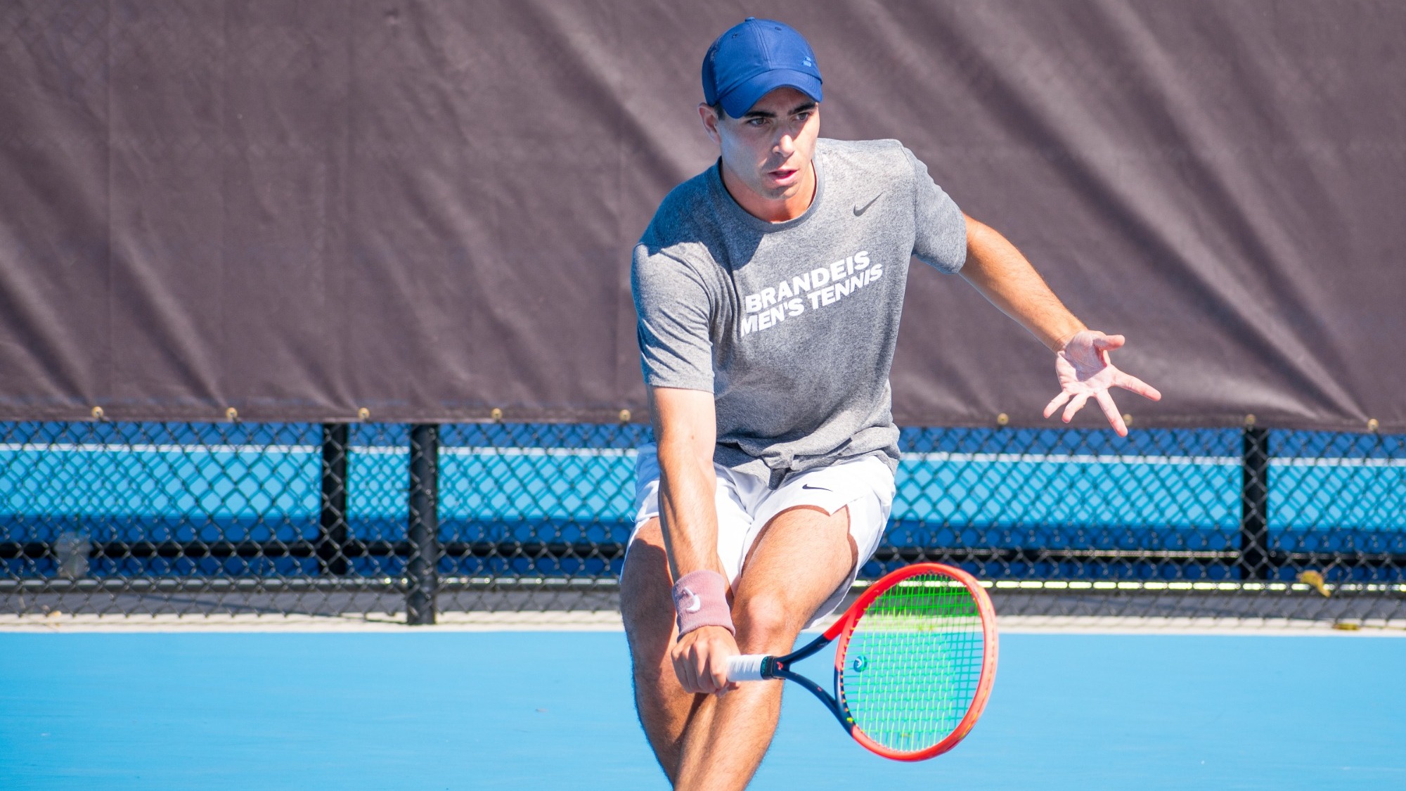 Daniel Shemesh reaches for a shot on the tennis court