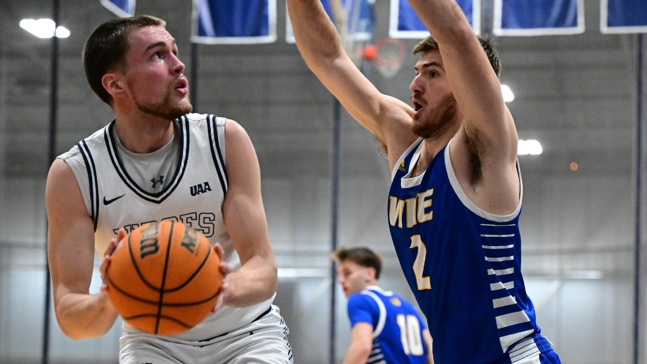 Elias Rodl pump fakes a defender during a basketball game