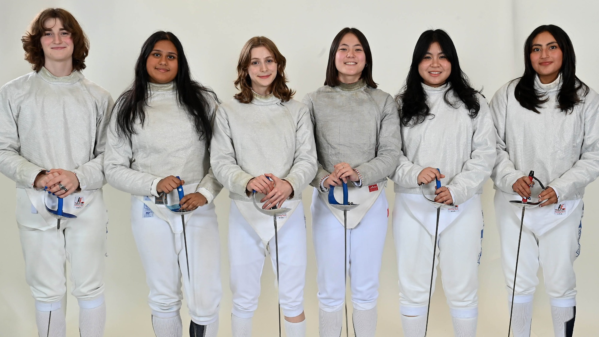 Six members of the women's saber squad posing for the camera