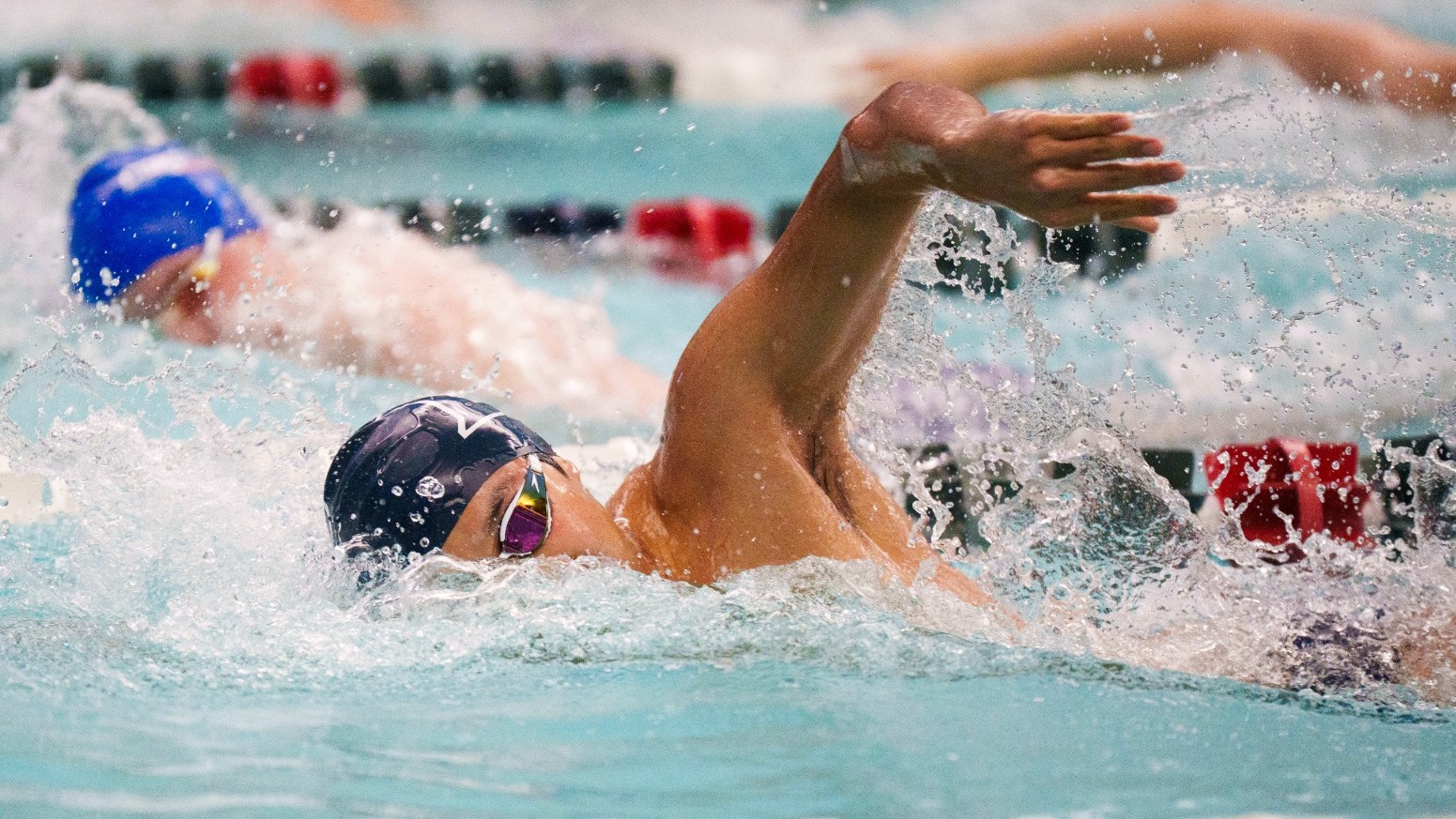 A Brandeis swimmer swimming freestyle during the Judges' meet against Coast Guard