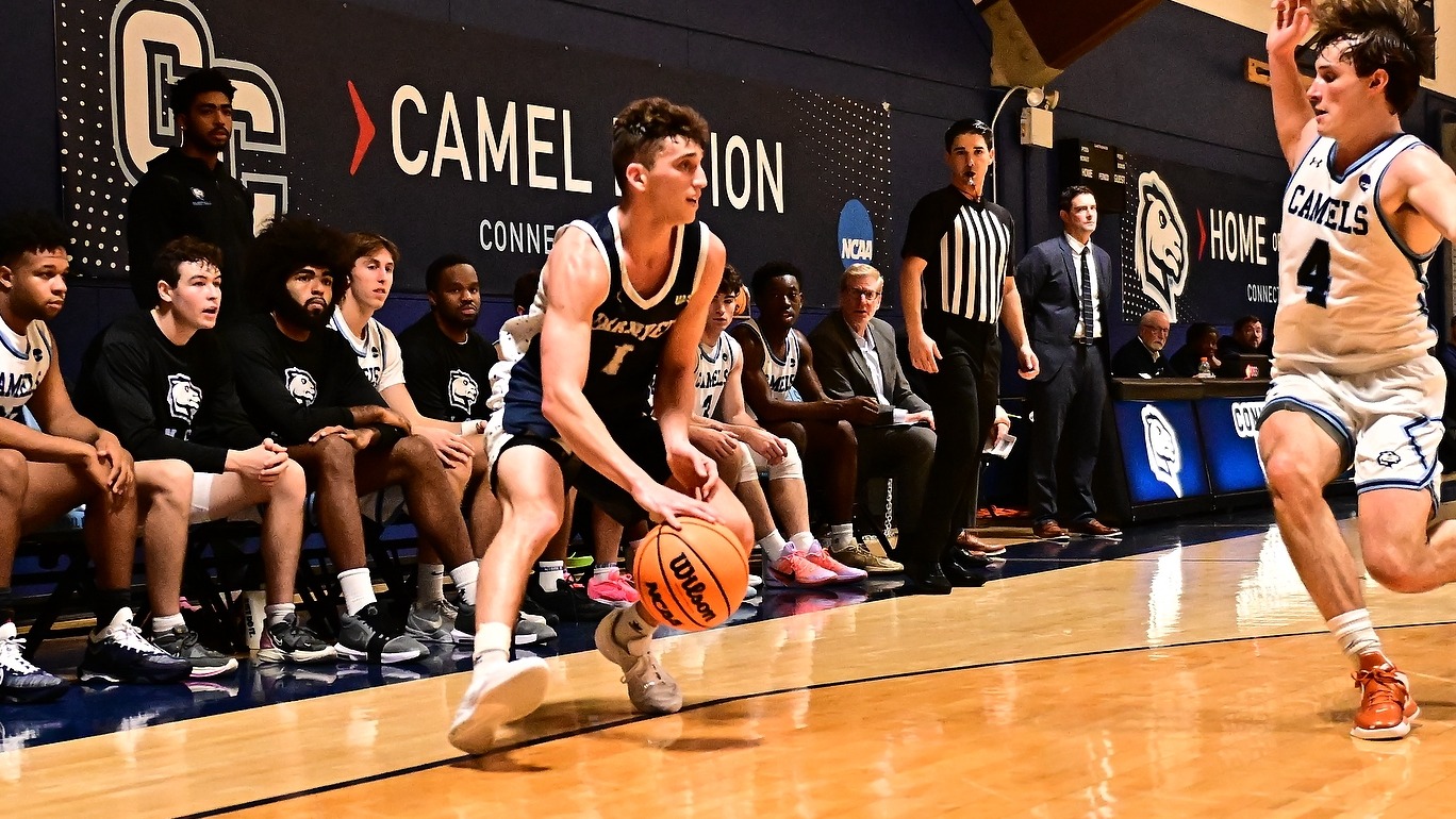 Alex Zakheim in the corner with the basketball as a defender comes after him