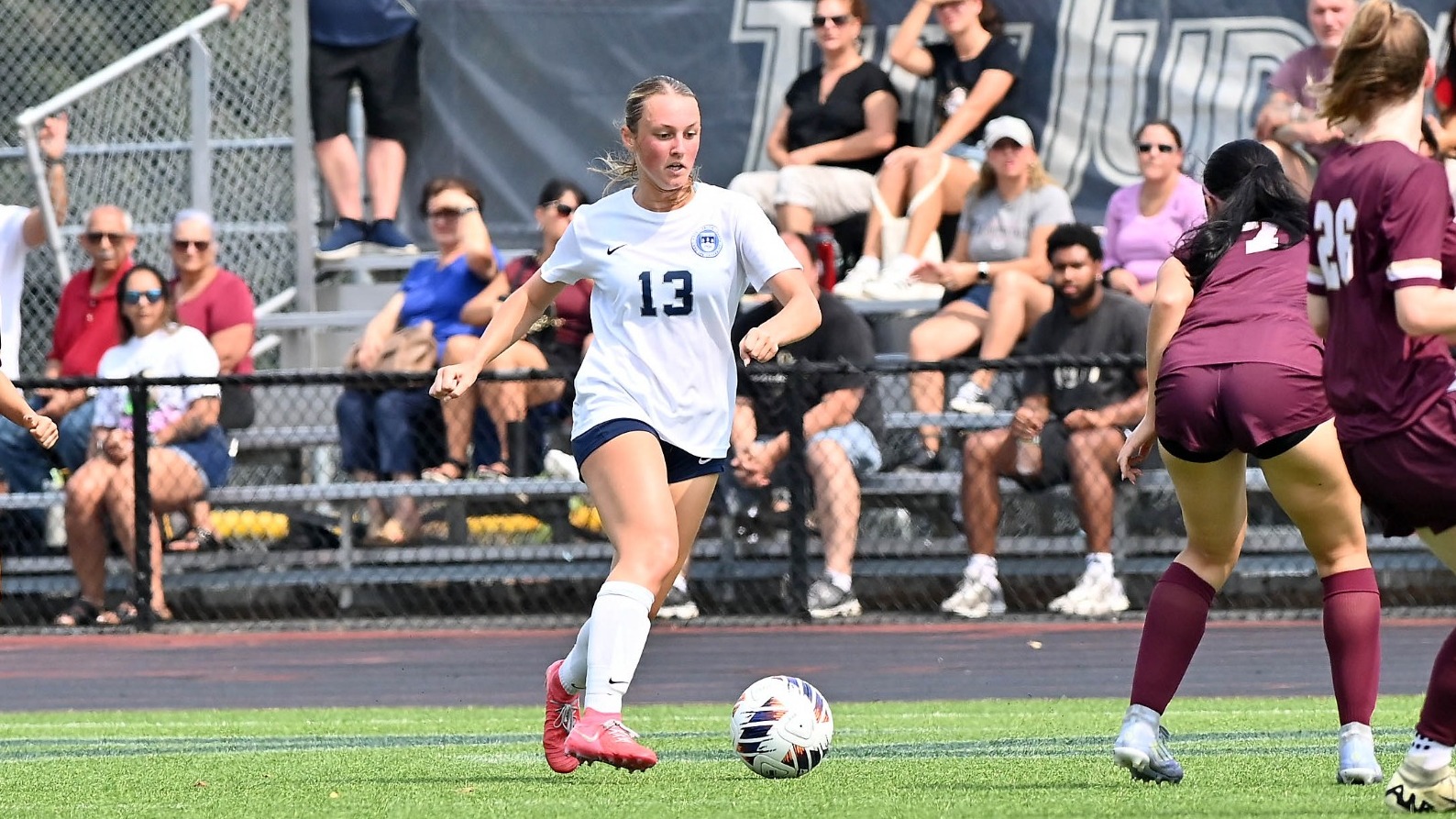Abby Kenkelen dribbles a soccer ball during a match