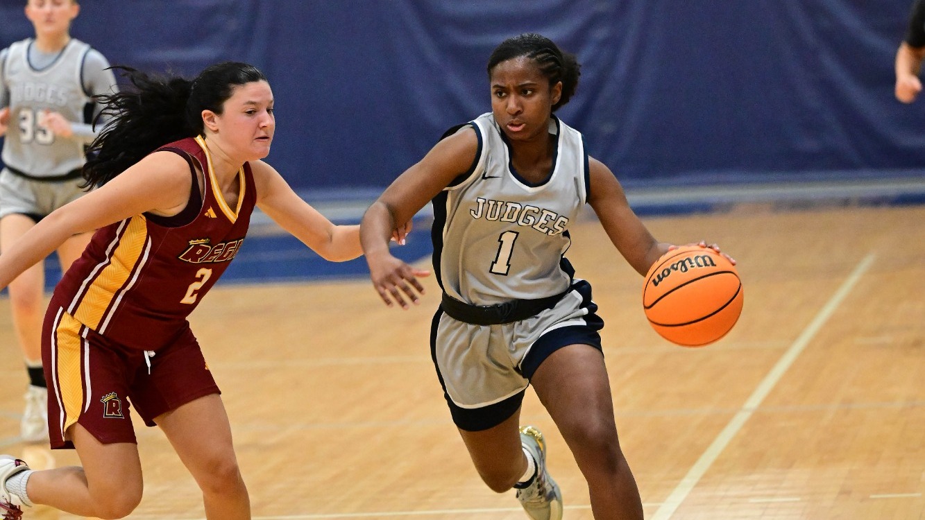 Jazzy Perez dribbles past an opponent during a basketball game