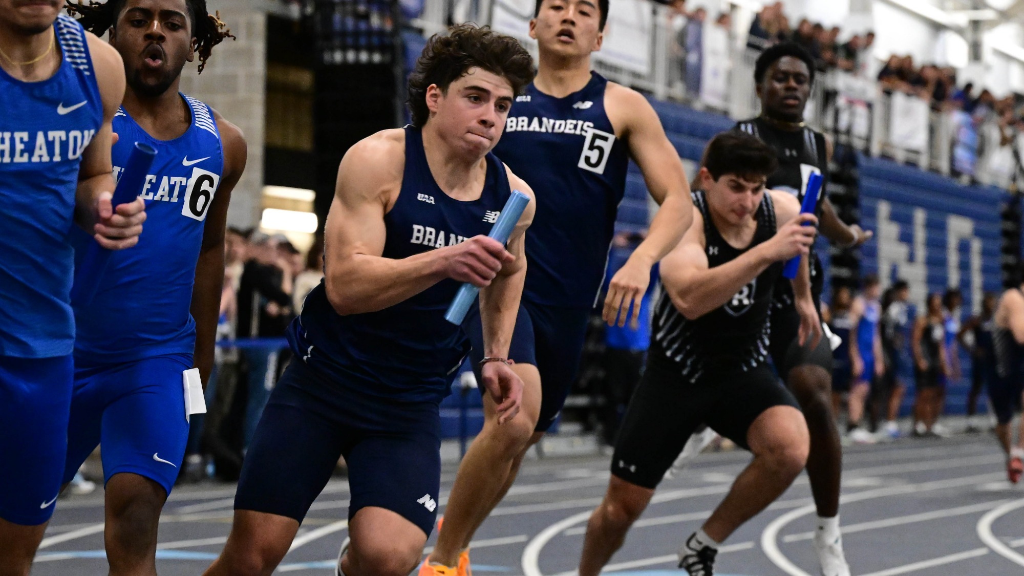 Danny Krigman receives the handoff during a 4x200-meter relay