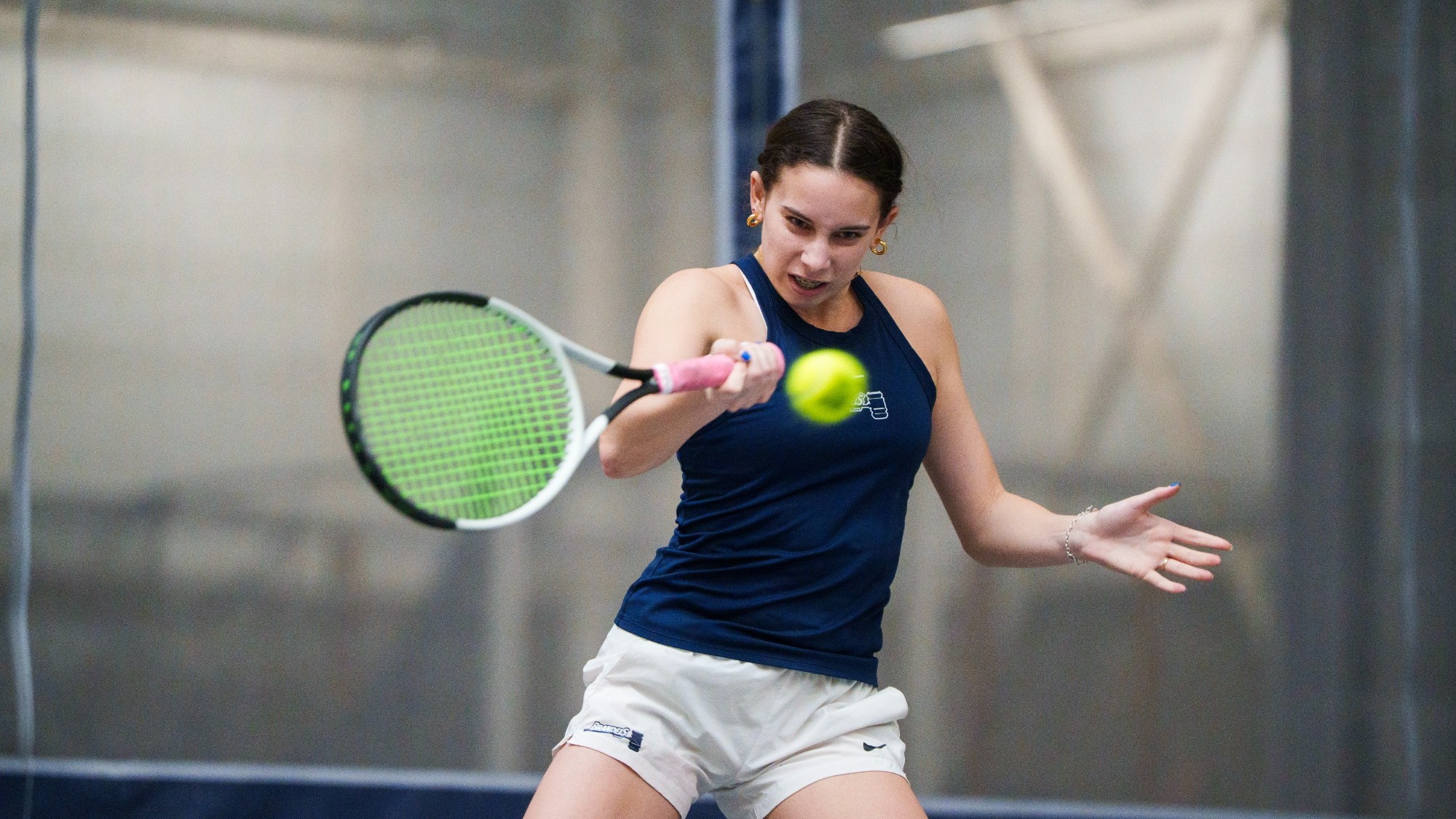 Charly Saltz hits a forehand during a tennis match