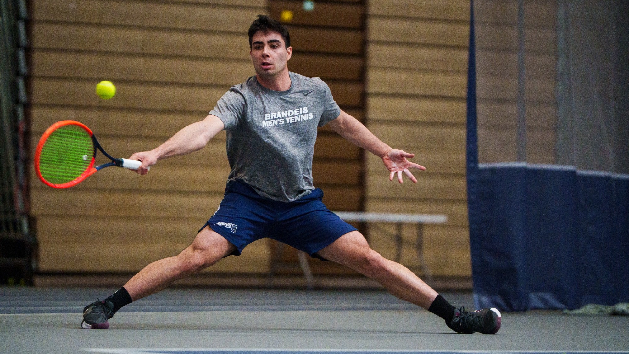 Daniel Shemesh reaches for a return during a tennis match