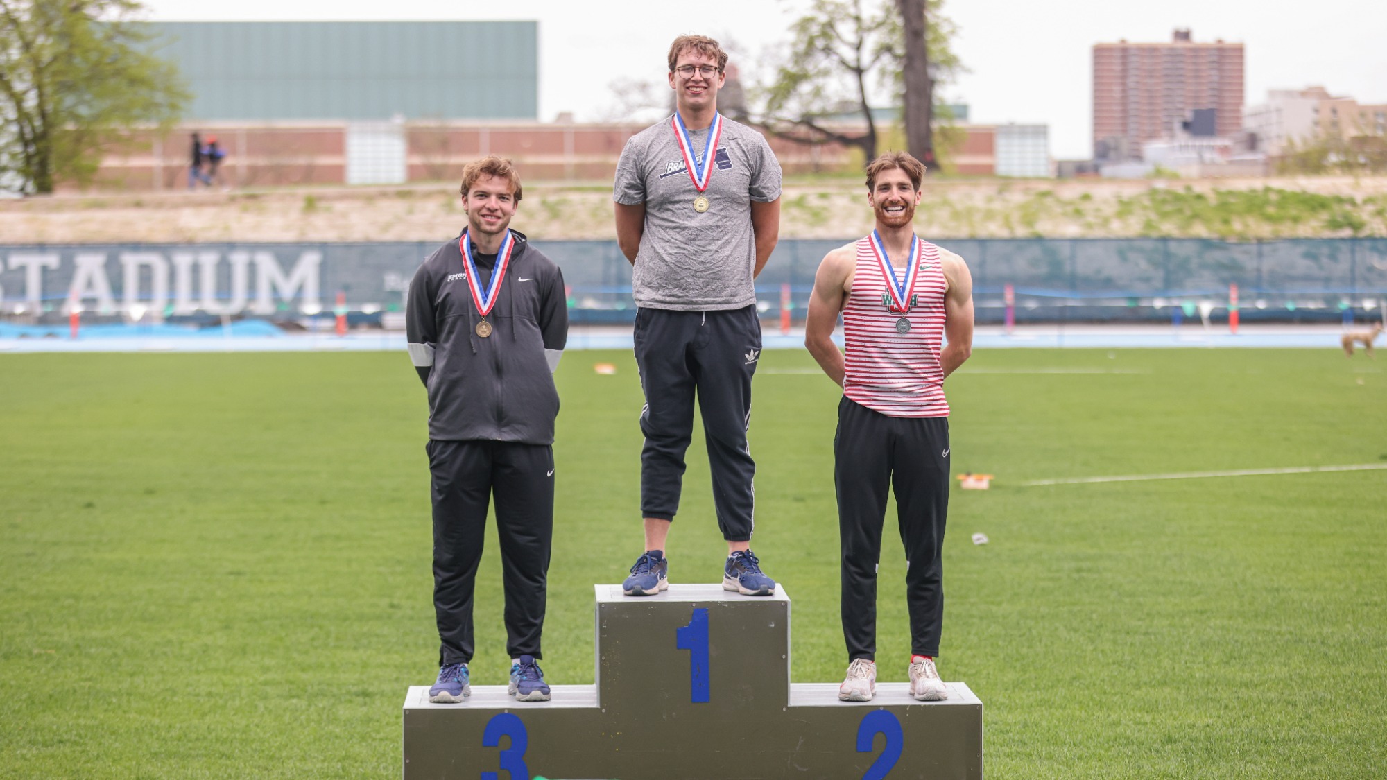 Sam Krause atop the podium at the UAA Outdoor Track and Field Championships