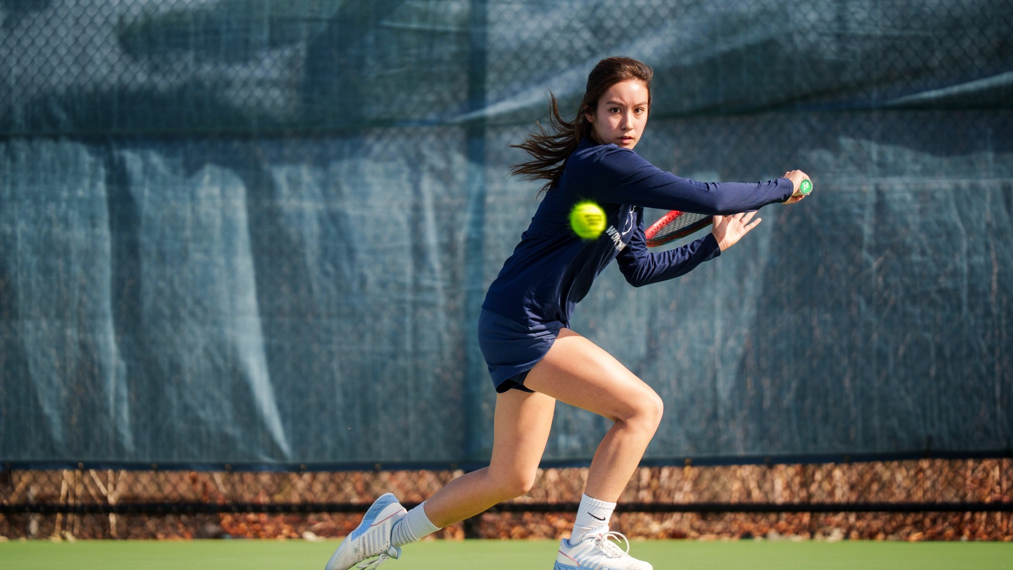 Mandy Reyes hits a backhand during a tennis match