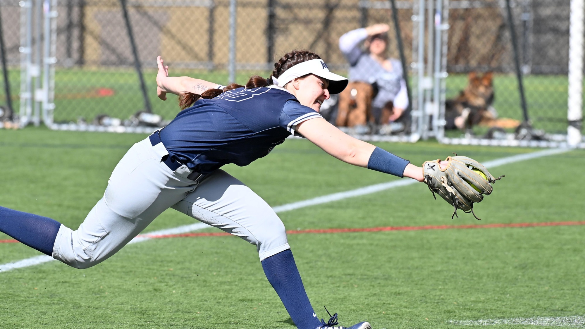 Maddie Manes stretches to catch a ball in right field