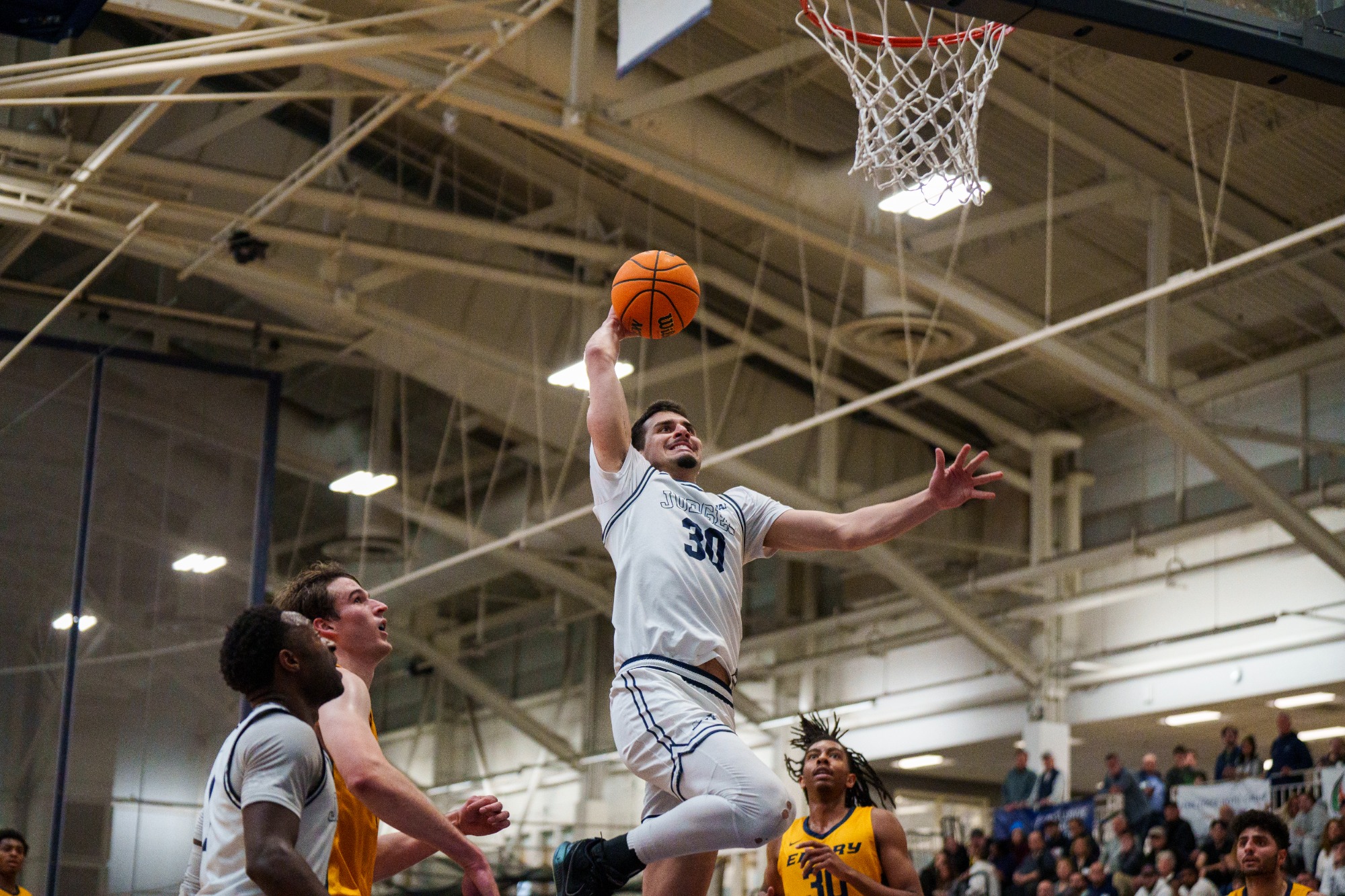 Recent graduate Toby Harris going in for the emphatic jam against Emory shows why he’s playing as a graduate transfer at Division I Iona this year.
