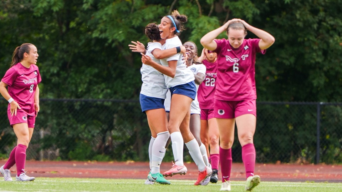 Brandeis women's soccer players celebrate the game-winning goal against MIT