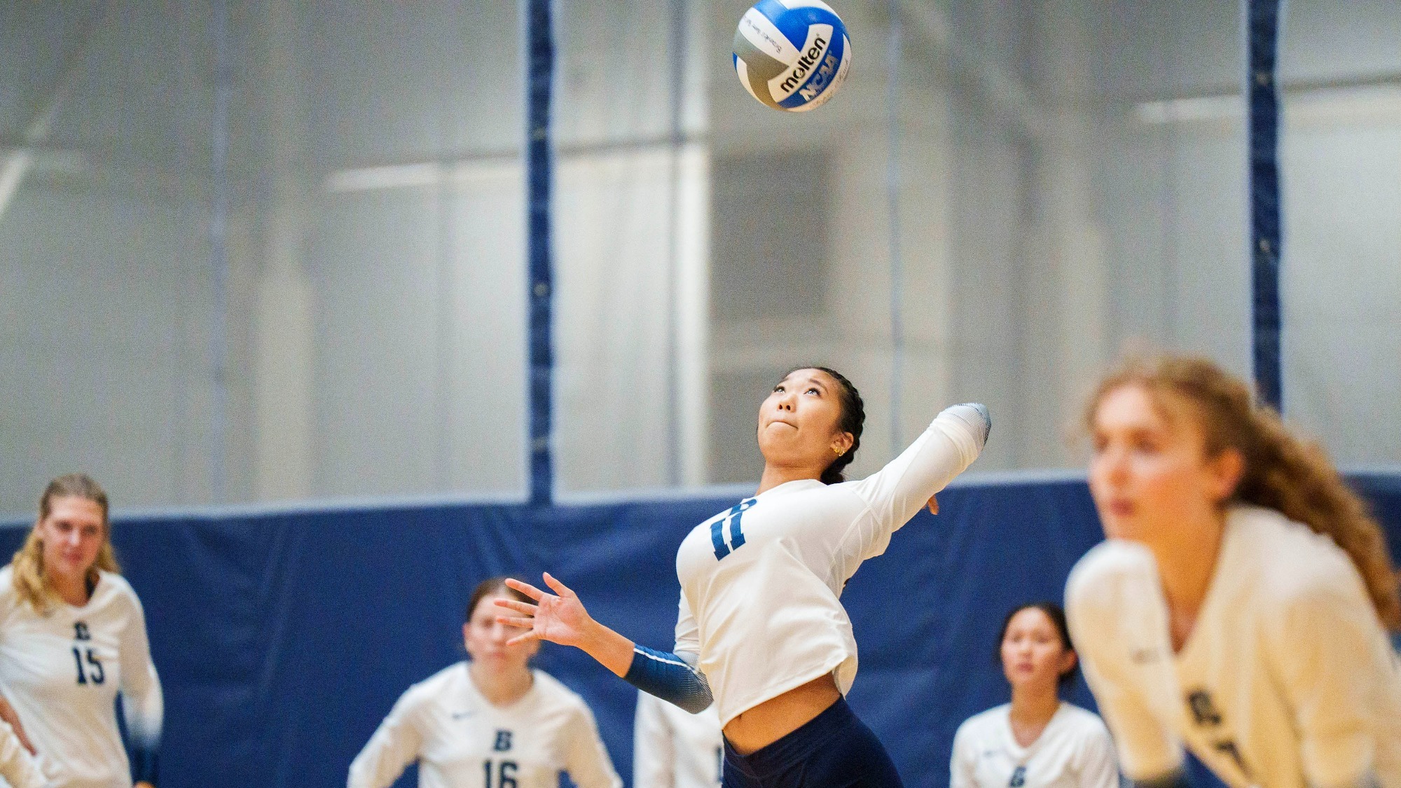 Alexa Ho serving a volleyball