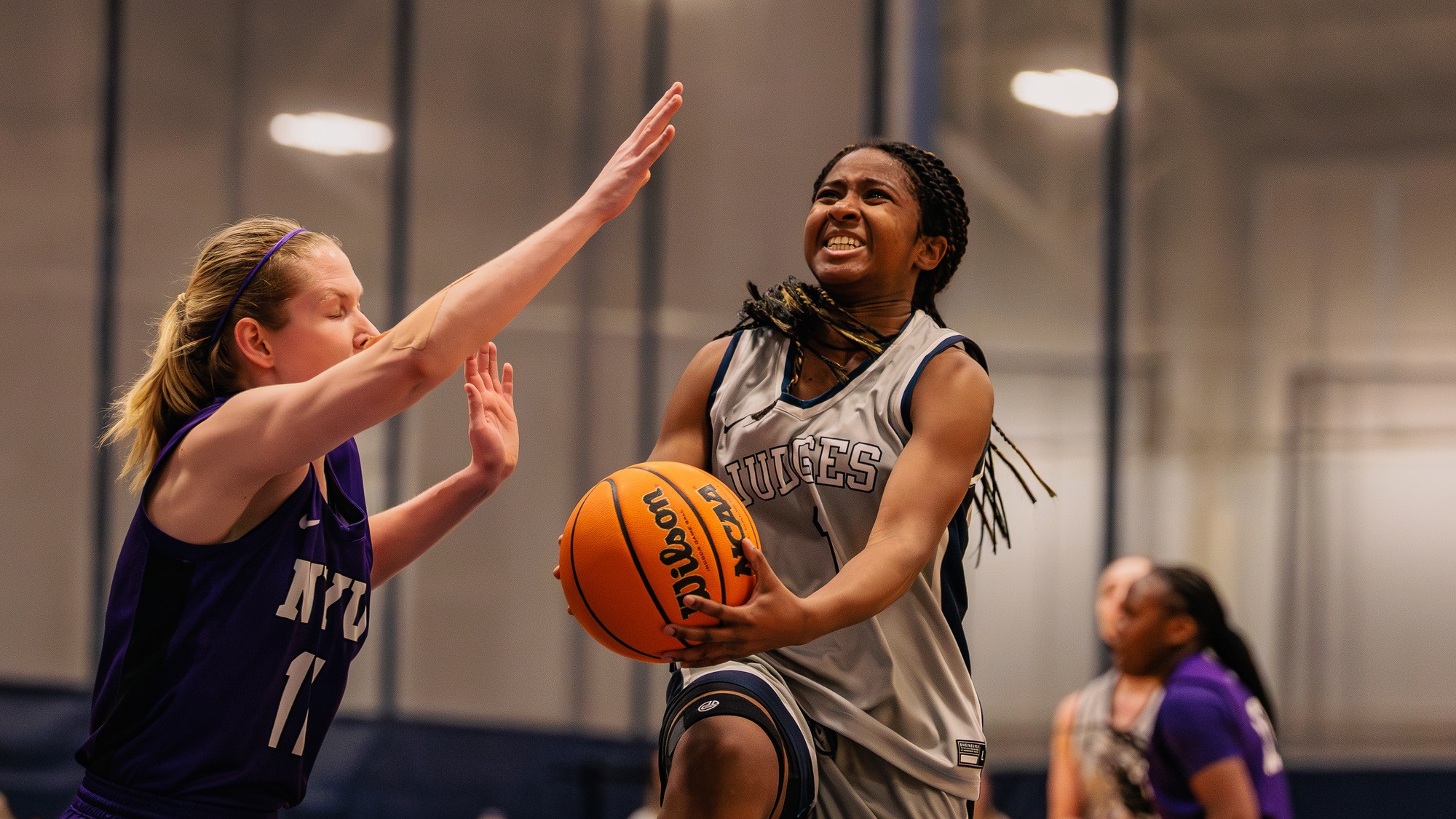 Jazzy Perez drives to the hoop with a defender in her way