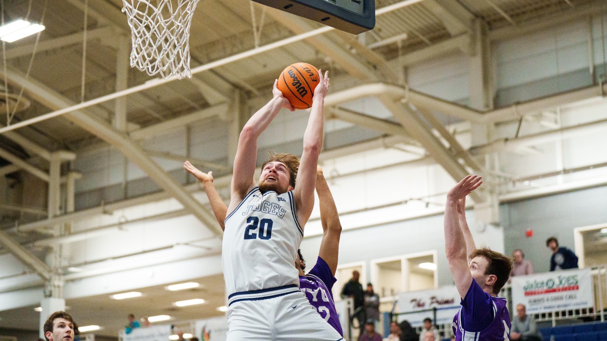 Elias Rodl grabs a rebound during a men's basketball game against NYU