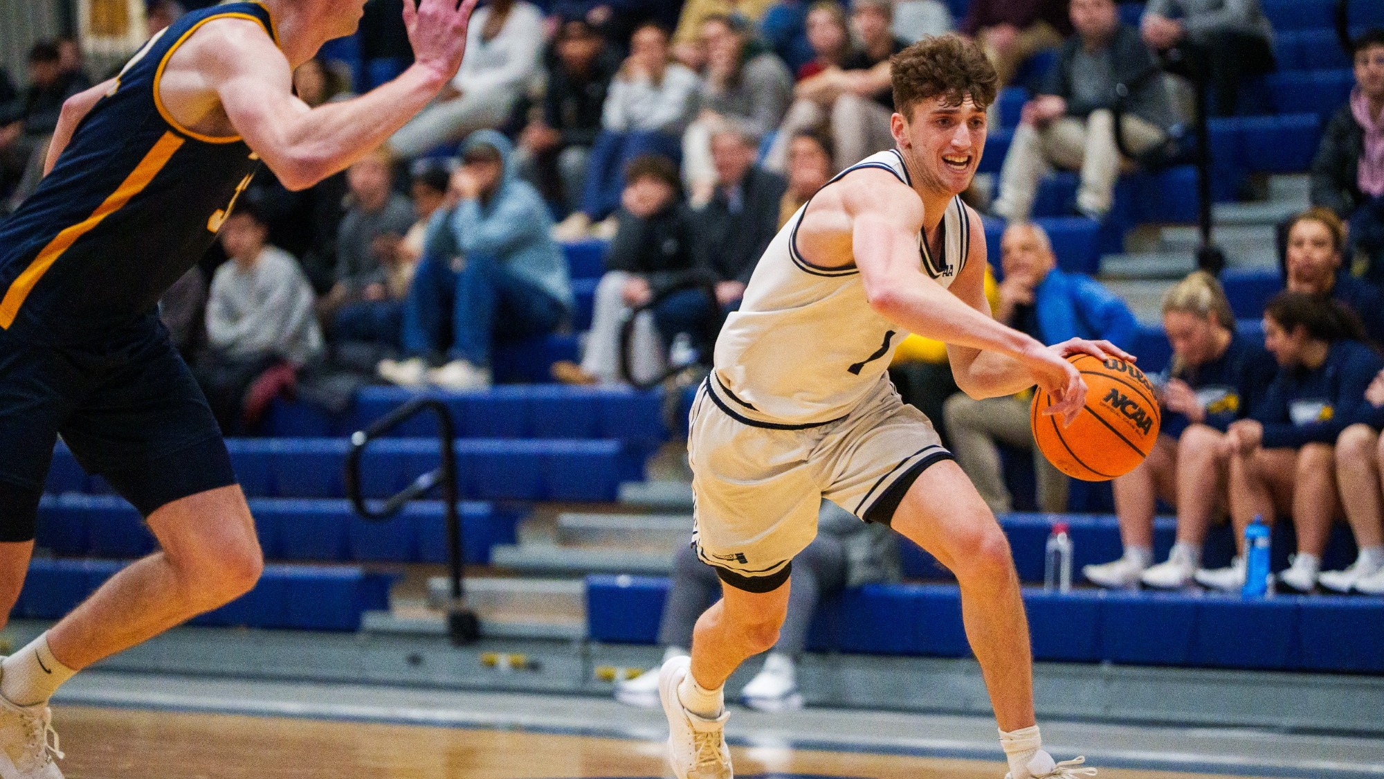 Alex Zakheim attacks the basket off the dribble during a basketball game
