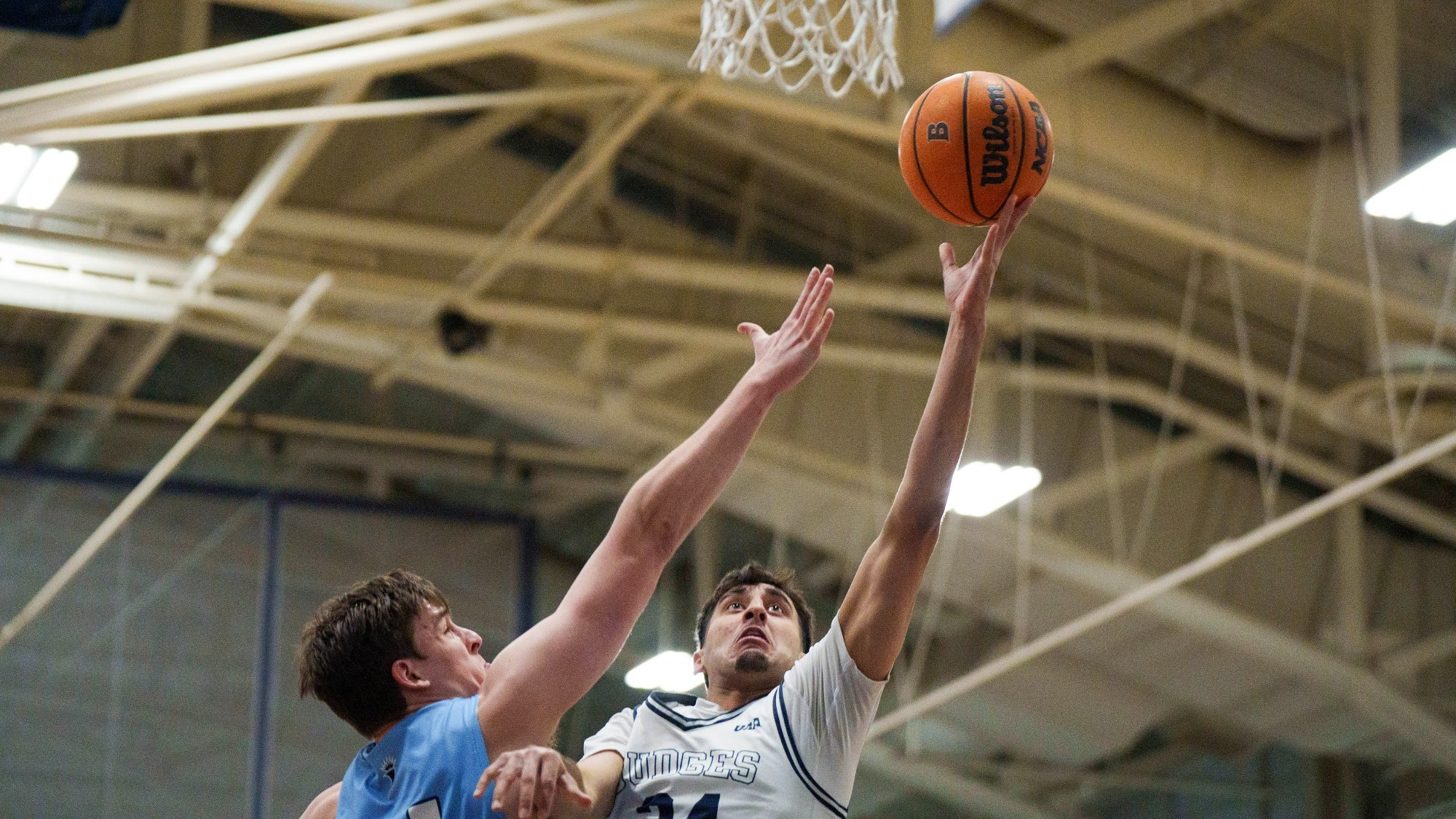 Gur Dhillon goes in for a lay-up against Lasell