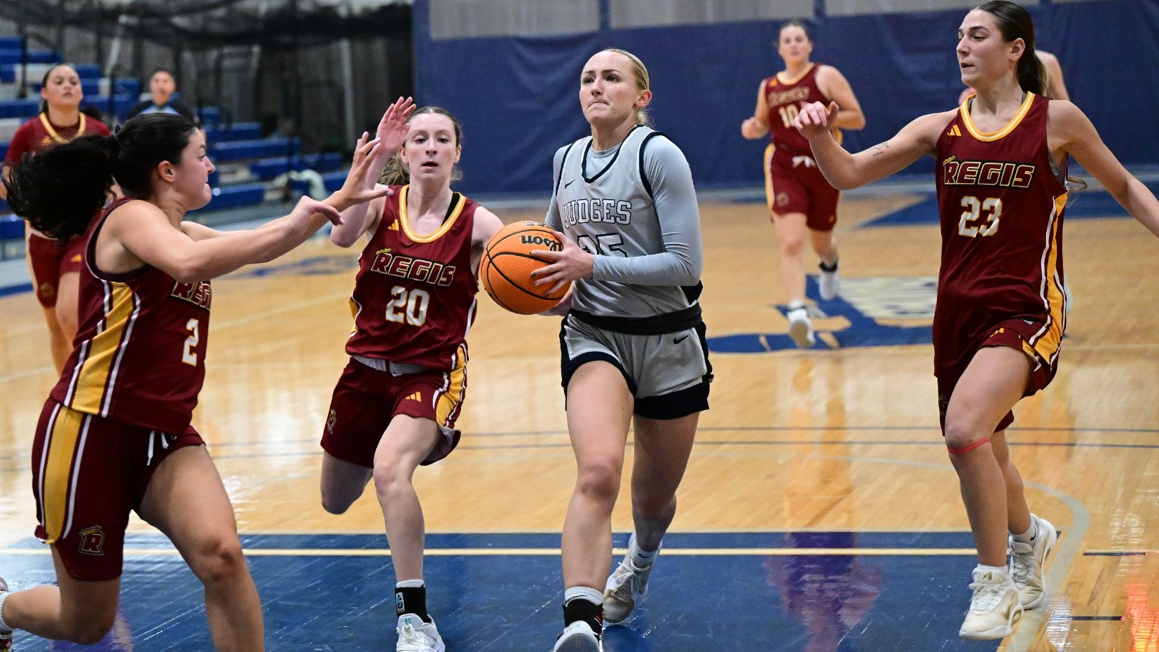 Abby Kennedy drives past three defenders during a basketball game
