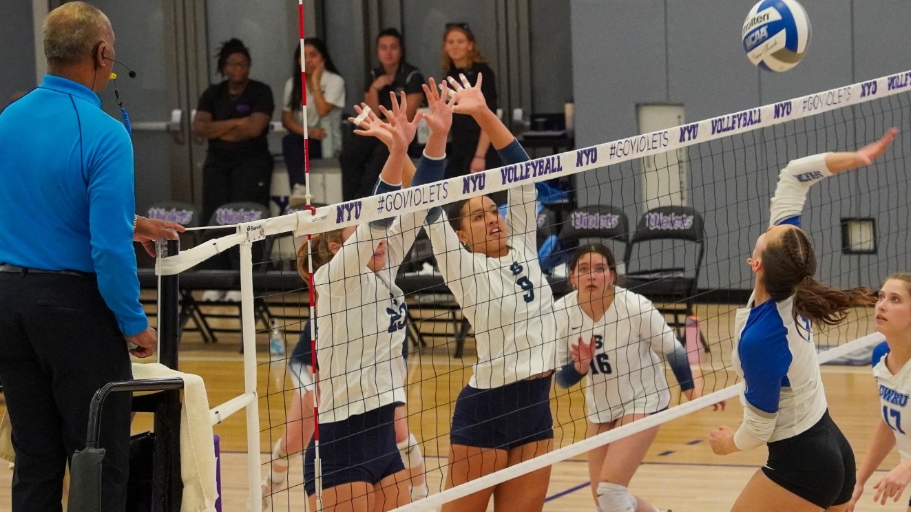 Madison Haft-Abromovitch and Talia Celotto deliver the game-winning block during a volleyball match