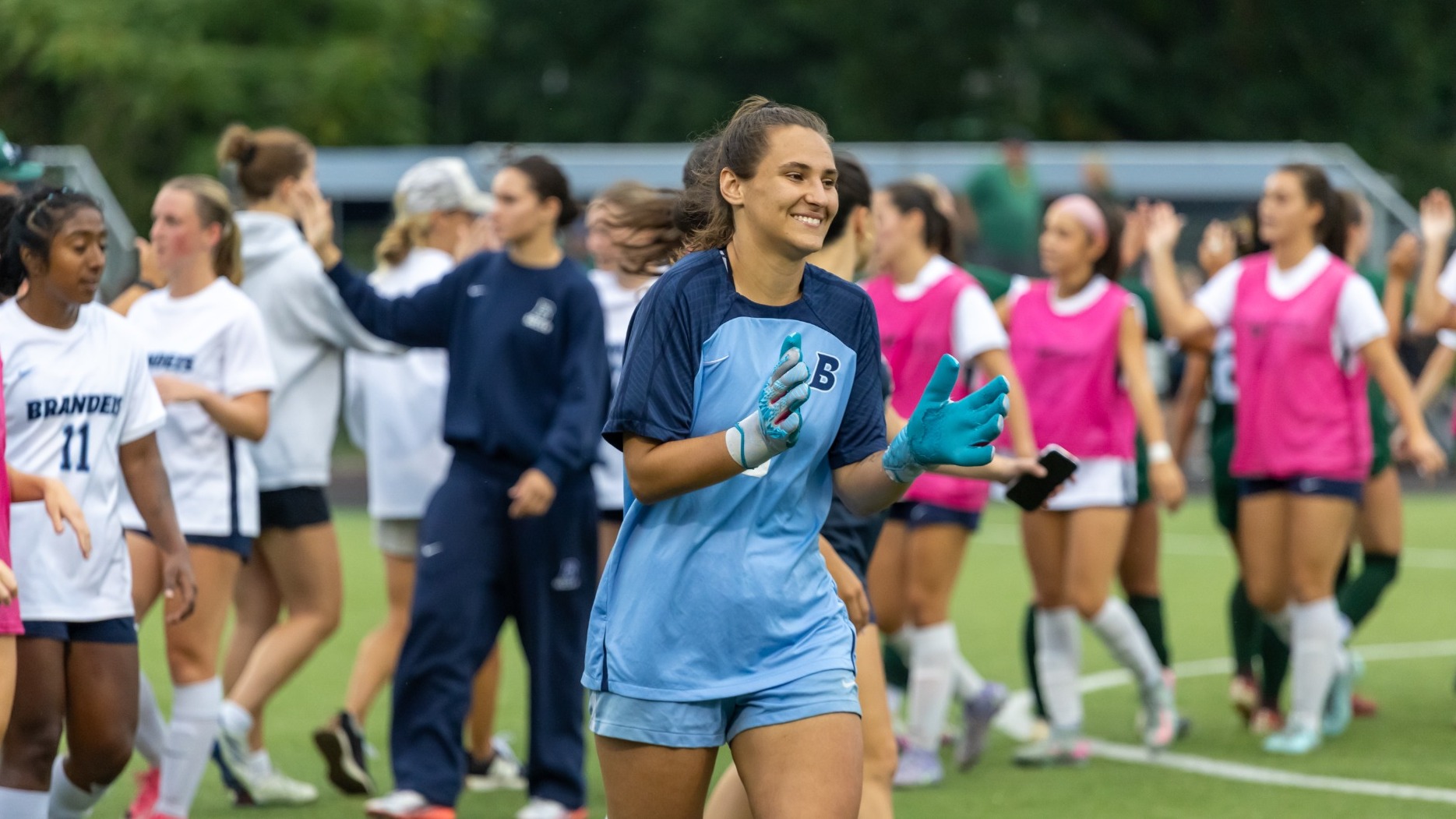 Amaya Logan clapping her hands during introductions of a women's soccer match