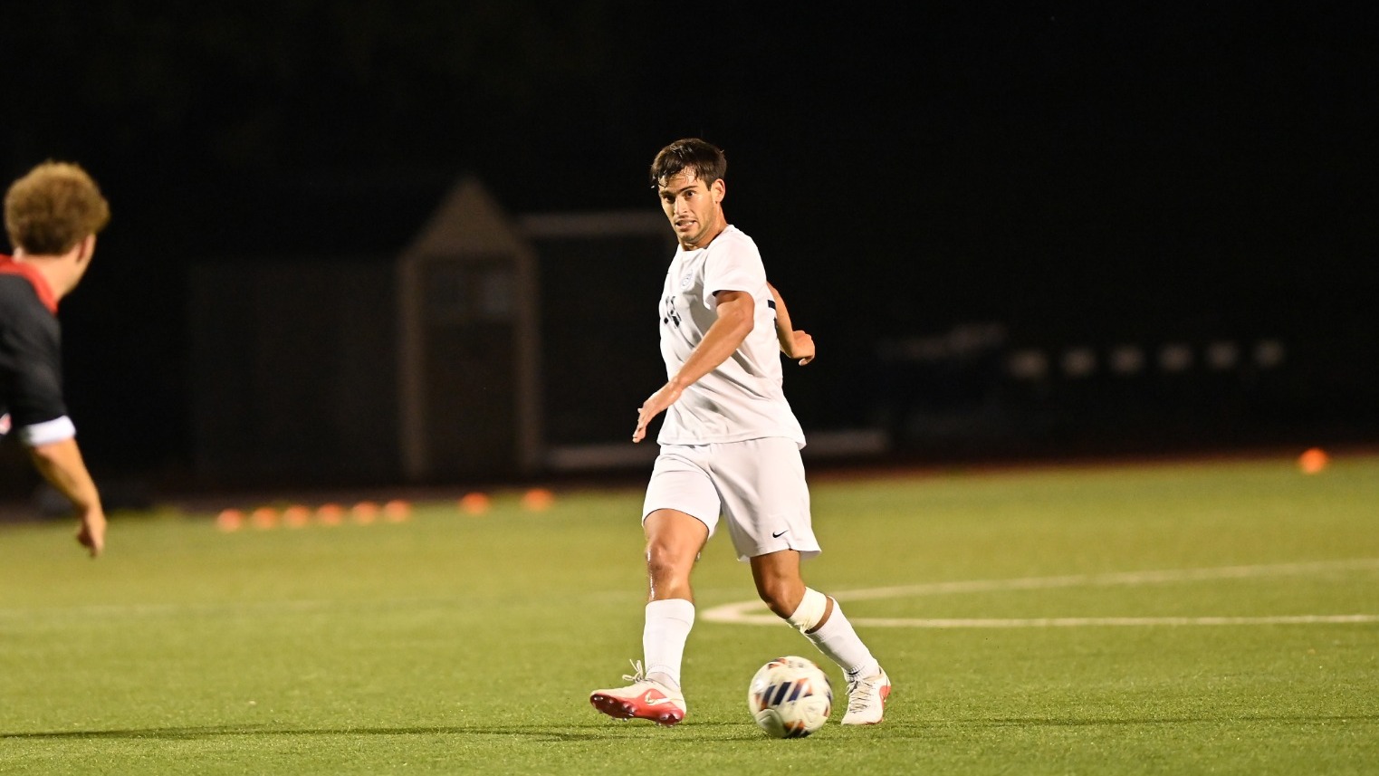 Yoav Feingold sends a pass along the turf during a soccer match